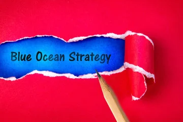 Peeling back paper to reveal blue ocean strategy