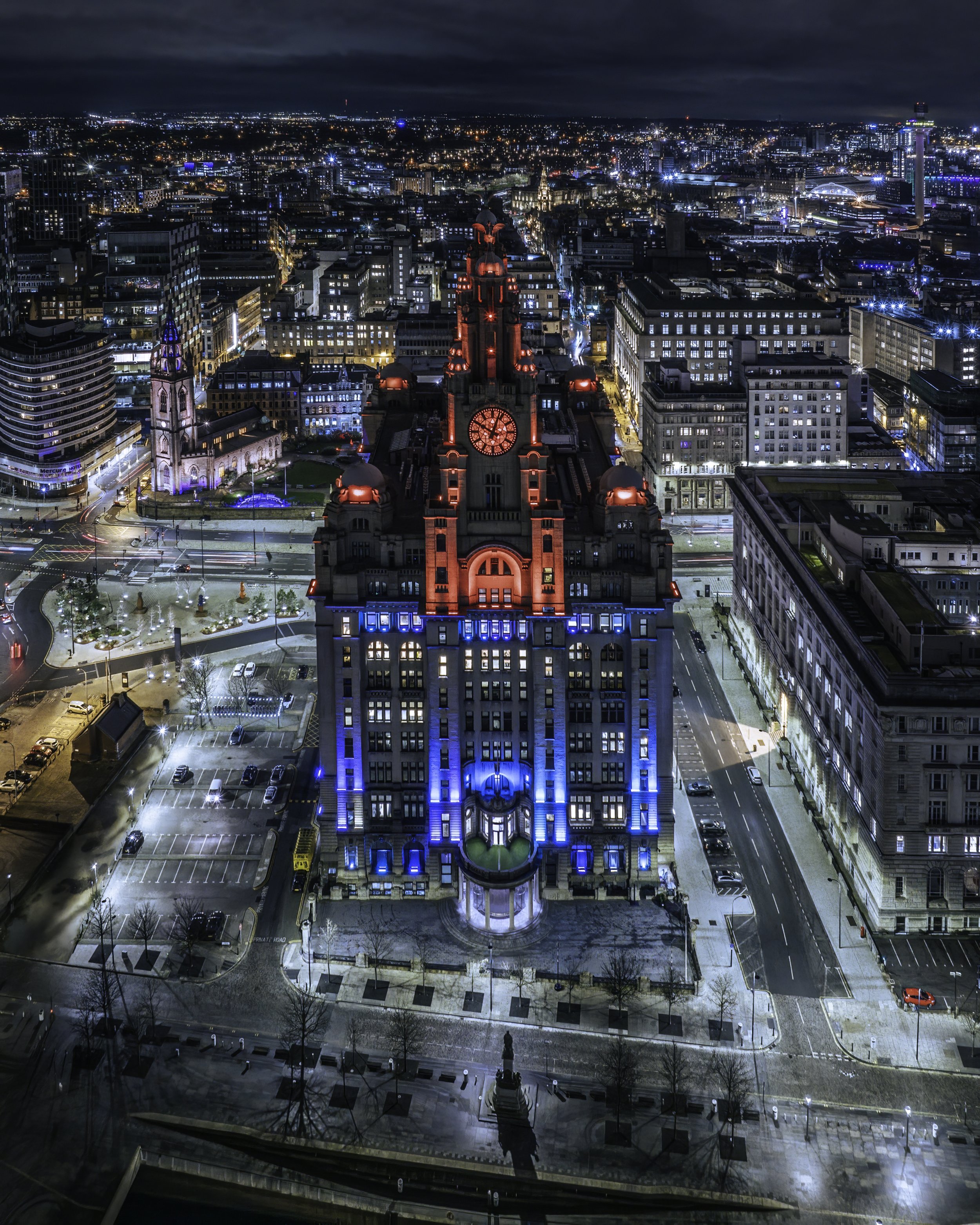 The Royal Liver Building in Liverpool lit up red and blue.