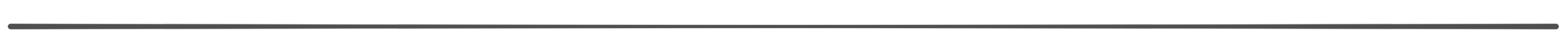 A close-up of a dark, horizontal object with a smooth surface, possibly a sleek electronic device or a piece of modern design.