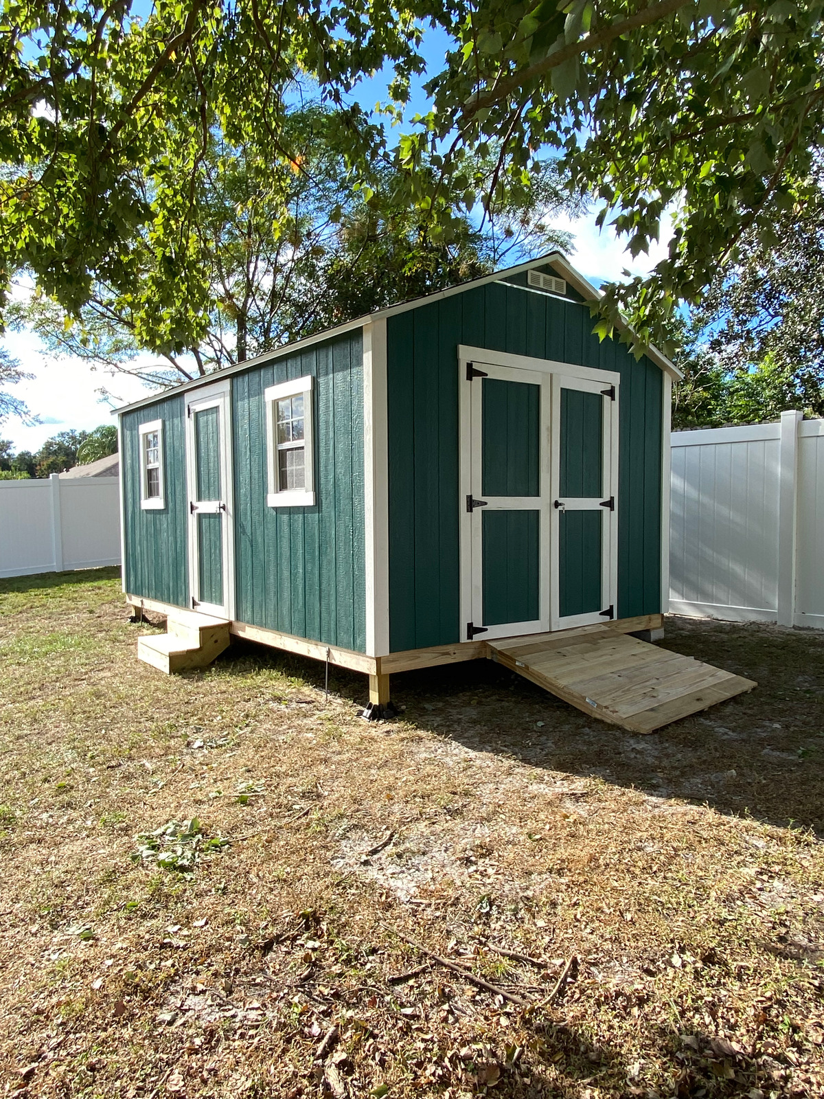 10x16 custom painted with extra single door, heavy duty ramp and single door step.