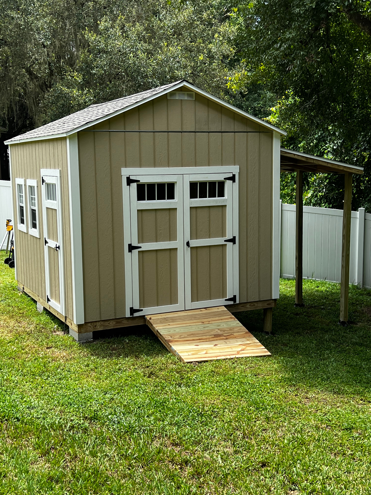 10x12 with transom double doors and extra transom single door, heavy duty ramp & 6x10 lean to roof.