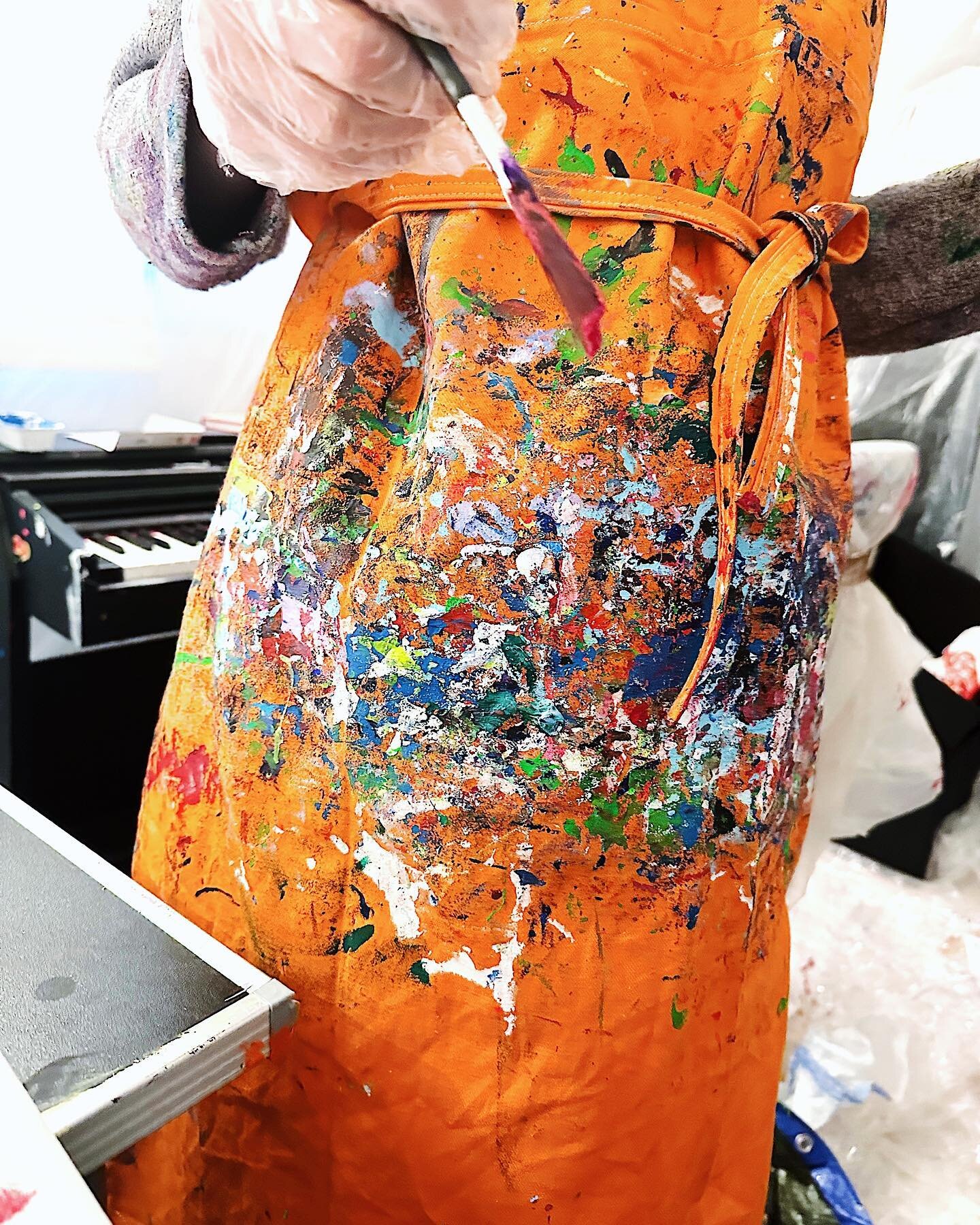 A closeup of @iamcecilelobert&rsquo;s work apron many have remarked on. Behind the infamous orange apron, is Lobert&rsquo;s piano, equally stained in paint. The artist steps aside whilst painting, to play her own piano compositions, only to go back t