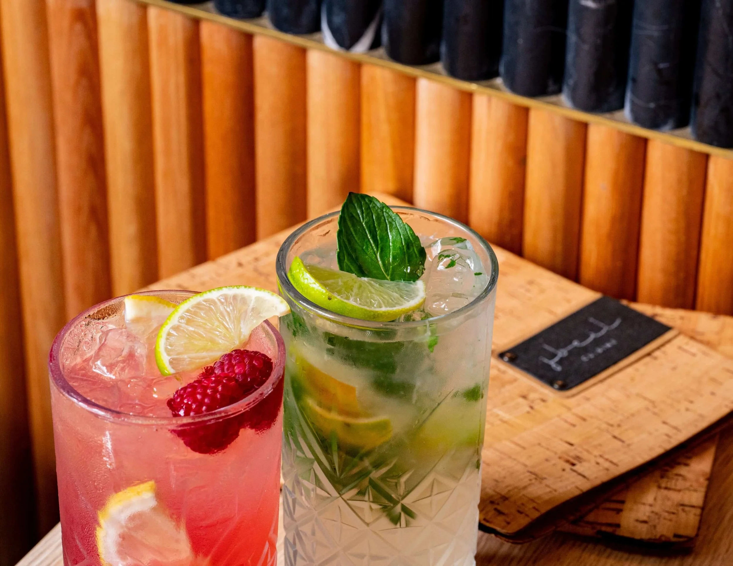  A bright pink and green cocktail with ingredients like Bacardi rum, fresh lime, fresh mint, sugar syrup, lime cordial, soda water 