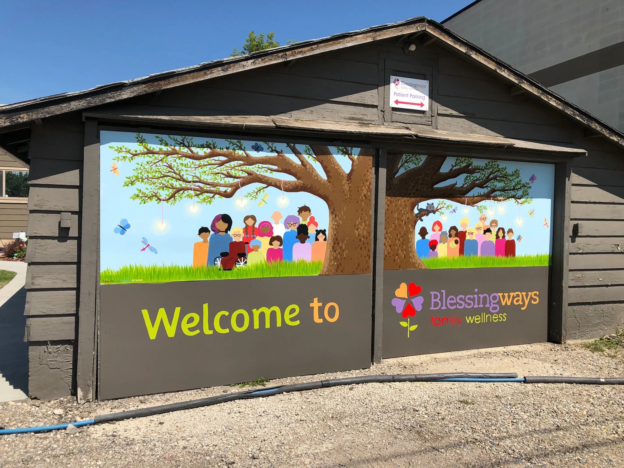 Full view of the Tree of Life mural at Blessingways Family Wellness in Airdrie, Alberta — a colorful community artwork showing people of diverse ages and backgrounds gathered around a flourishing tree symbolizing growth and connection.