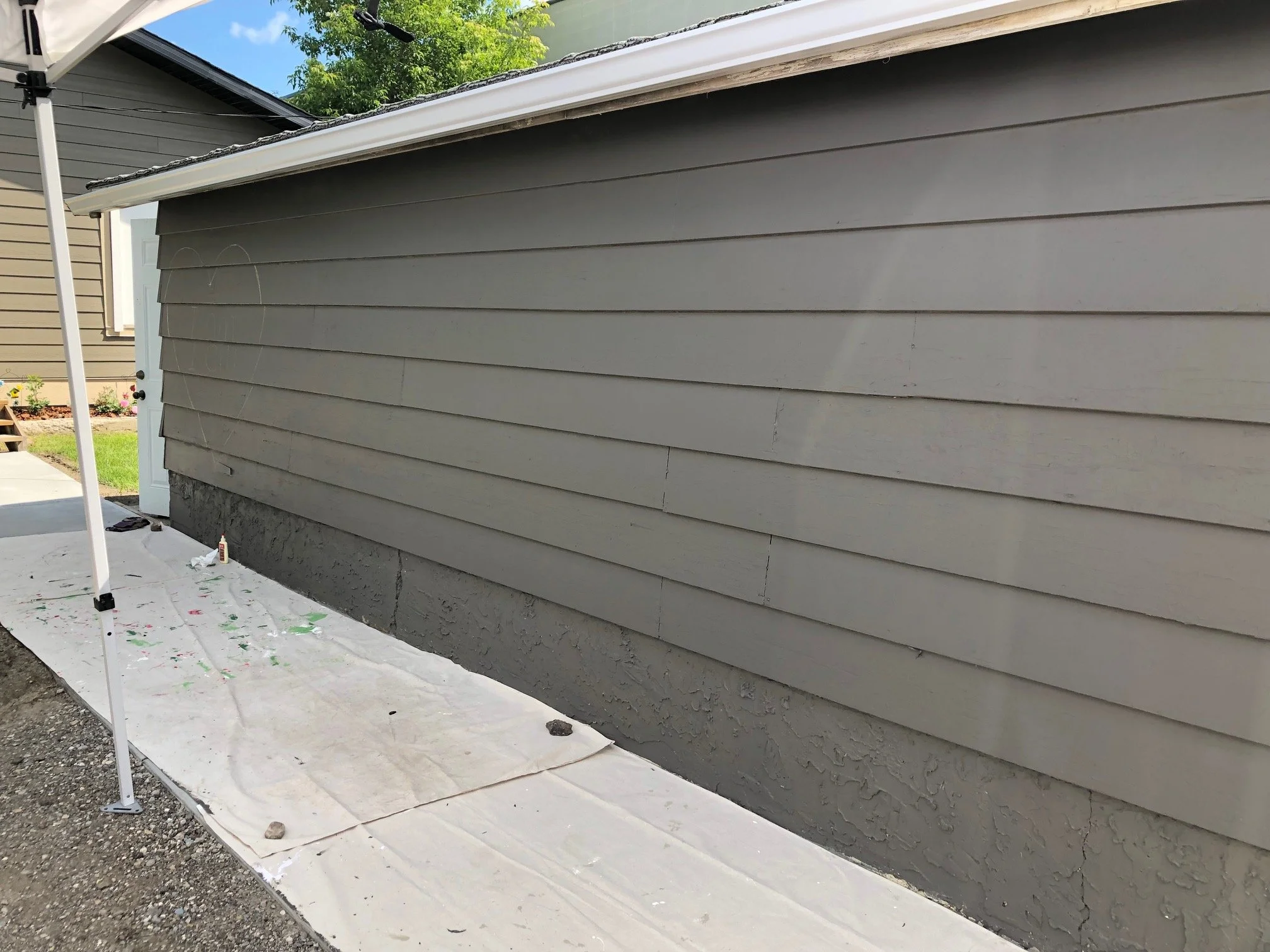 Before photo of the Blessingways Family Wellness garage doors in Airdrie, Alberta, showing the space that would become the colorful Affirmation Wall mural.
