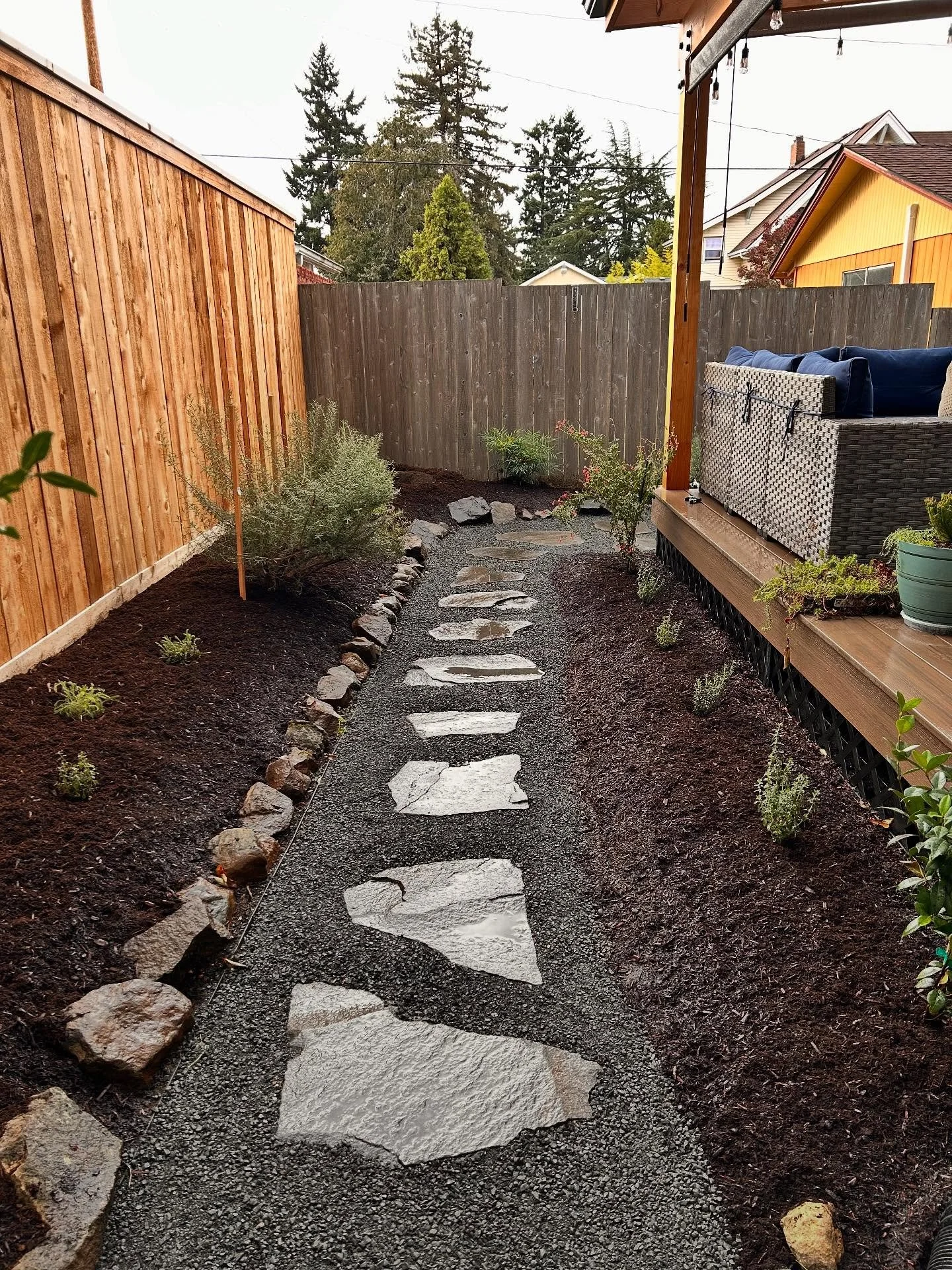 More plants, small stone paths, and mulch to make everything tidy and cozy going into winter. 
&bull;
We went with some natives, some native cultivars, and some tough, drought tolerant ornamentals. Everything from Huckleberries to Bleeding Hearts to 