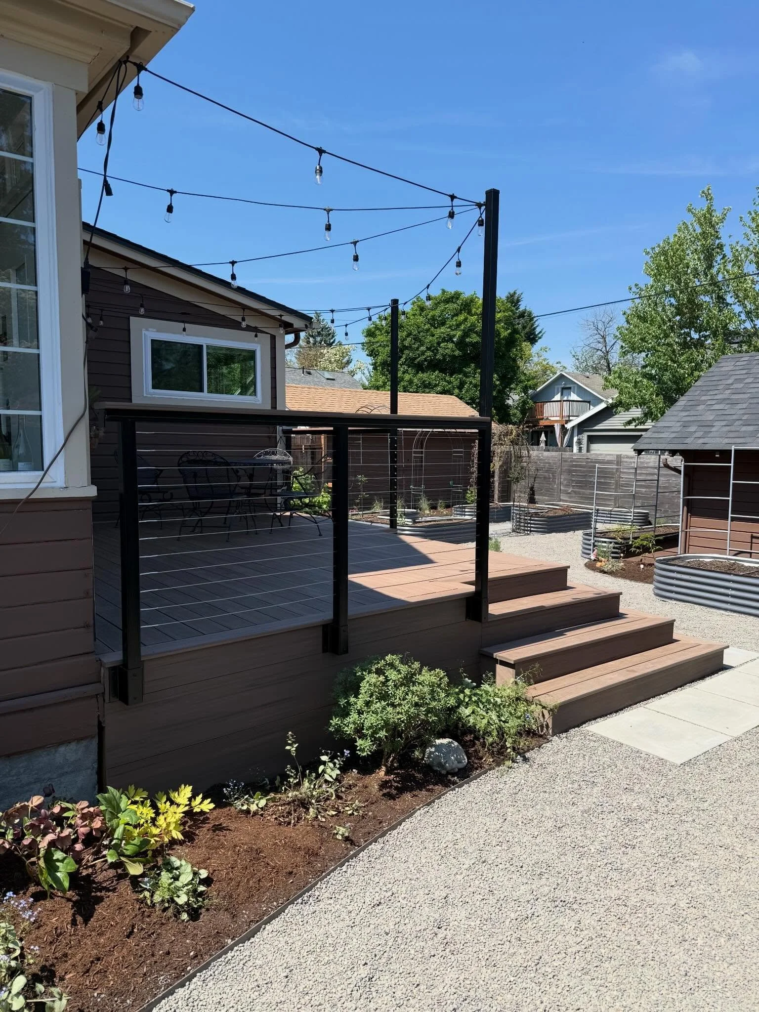 Woweee!! This one wins the award for most dramatic. 
&bull;
From old patio and overgrown hedge to useable deck and manageable planting, this one had some big changes. 
&bull;
The raised beds had already been placed in the sunniest spots, so we plante