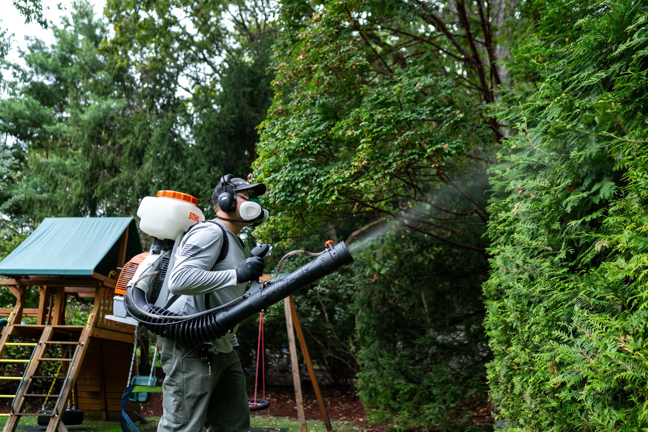 Mosquito Spraying with Playset in background