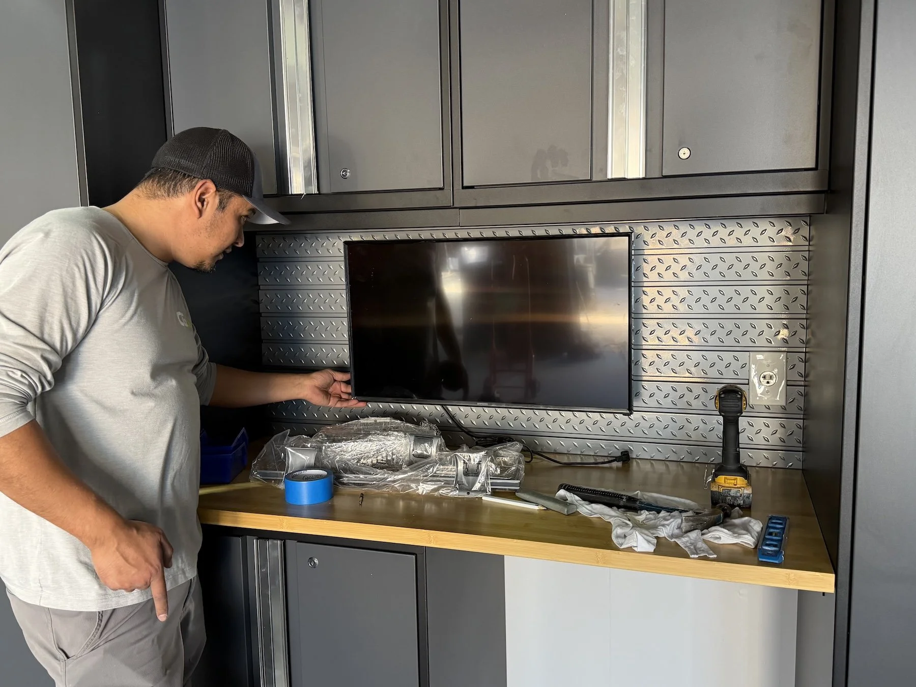 Modern garage makeover with custom garage cabinets, overhead storage racks, and functional garage organization in Colorado