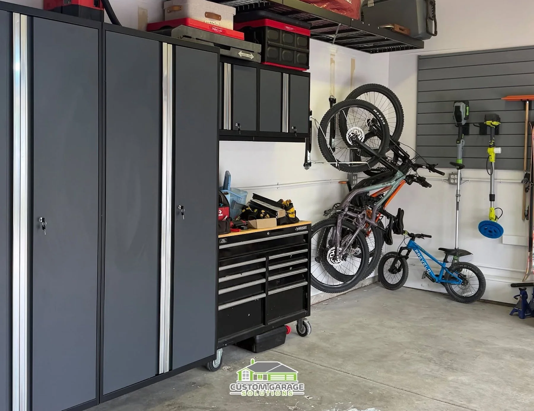 Organized garage with designated storage for bikes, sports equipment, and tools