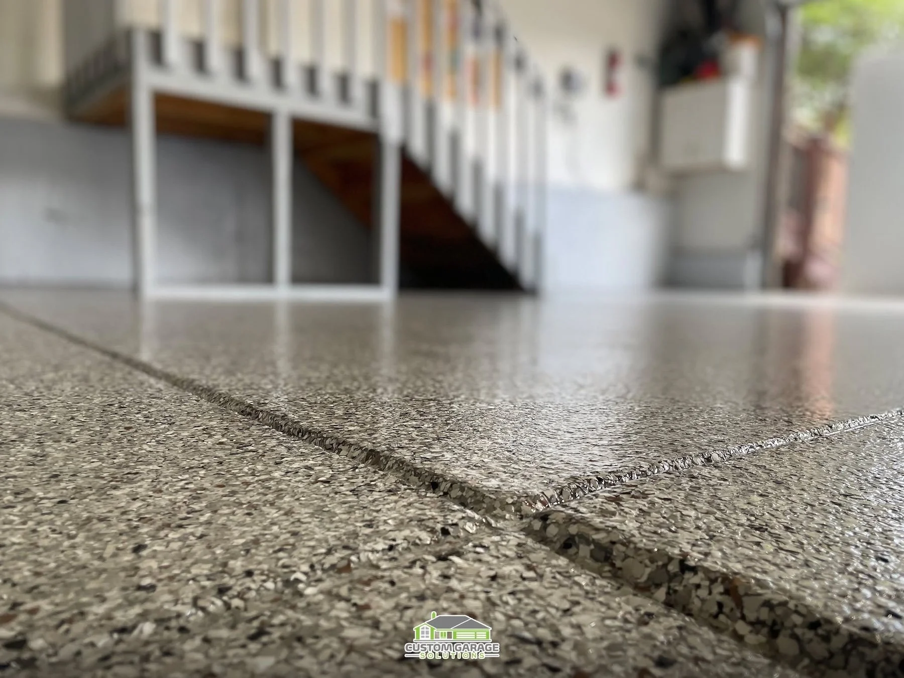 Garage floor coating designed to resist hot-tire pickup and summer heat