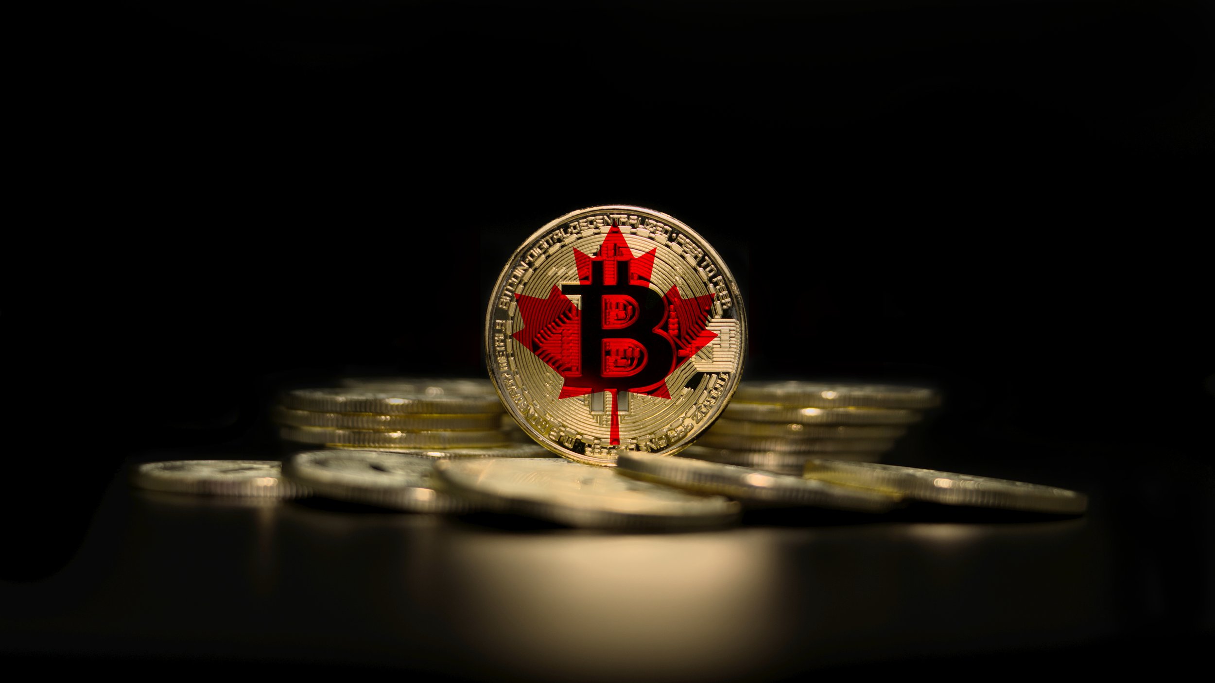 Canadian BItcoin, Bitcoin Coins stacked on Each other with the center being a Bitcoin with a canadian flag on it