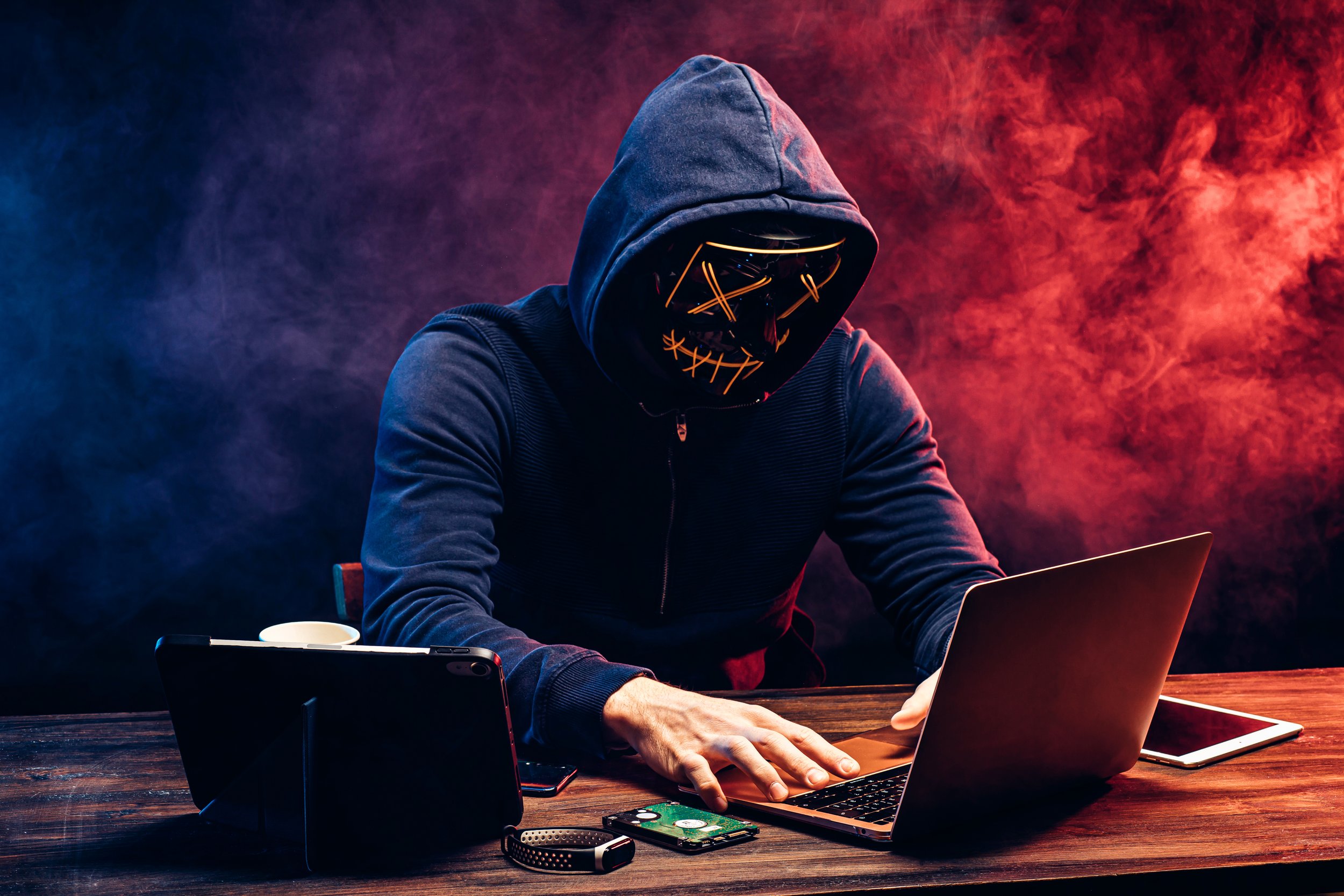 undiscript person hacking on a laptop