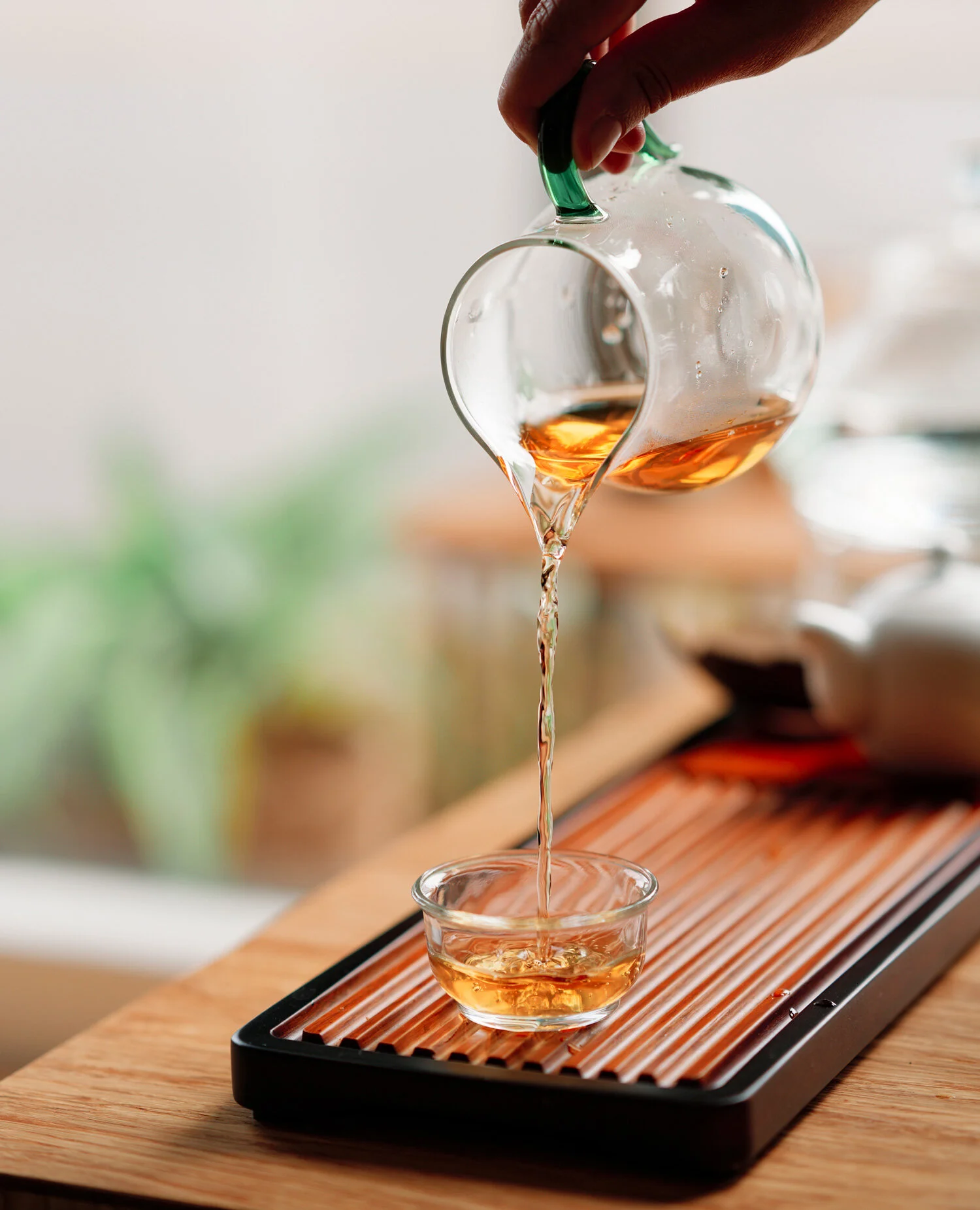 House Nine Wellness and Tea  - Image of tea pouring. Fire cupping, hot stones, Portland massage and tea shop, acupuncture therapy