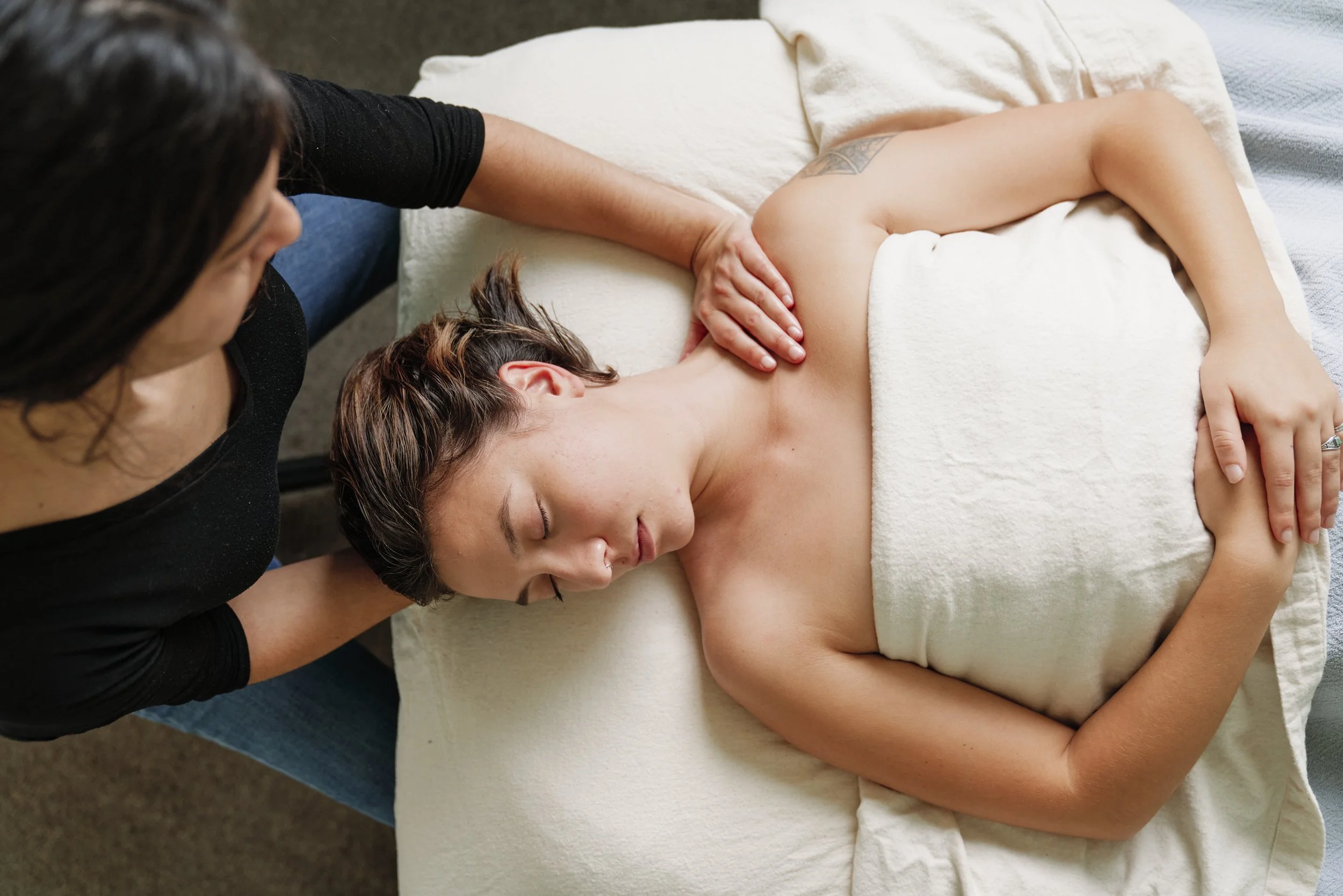 Person receiving massage for their neck and shoulder tension