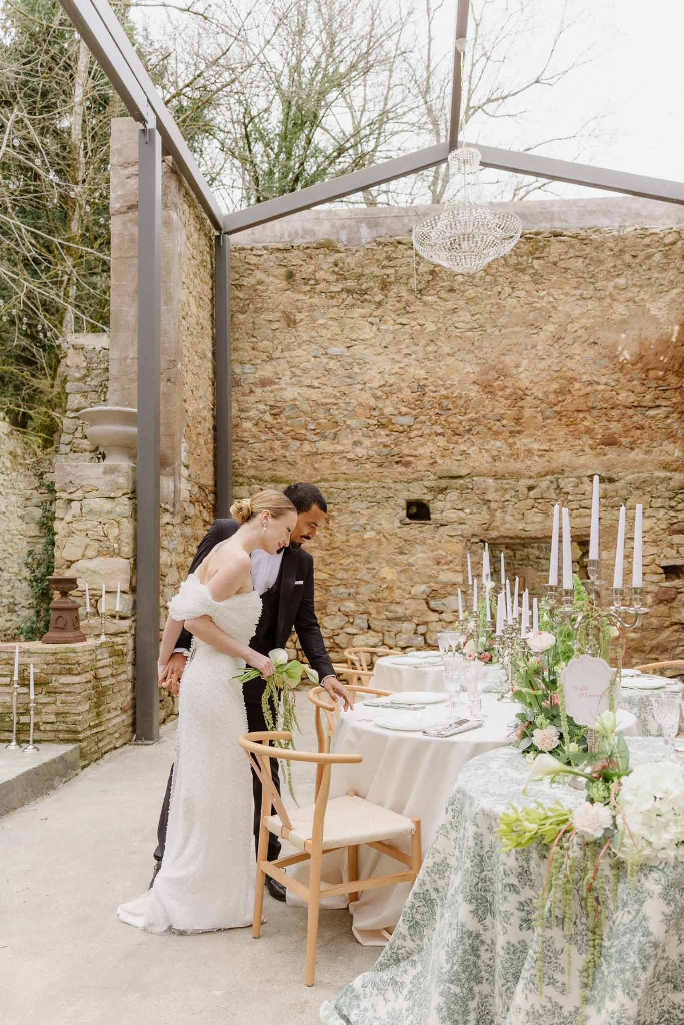 Chateau-du-Pont-Bourget-Lina-Bernard-bride-groom-checking-reception-table.jpg
