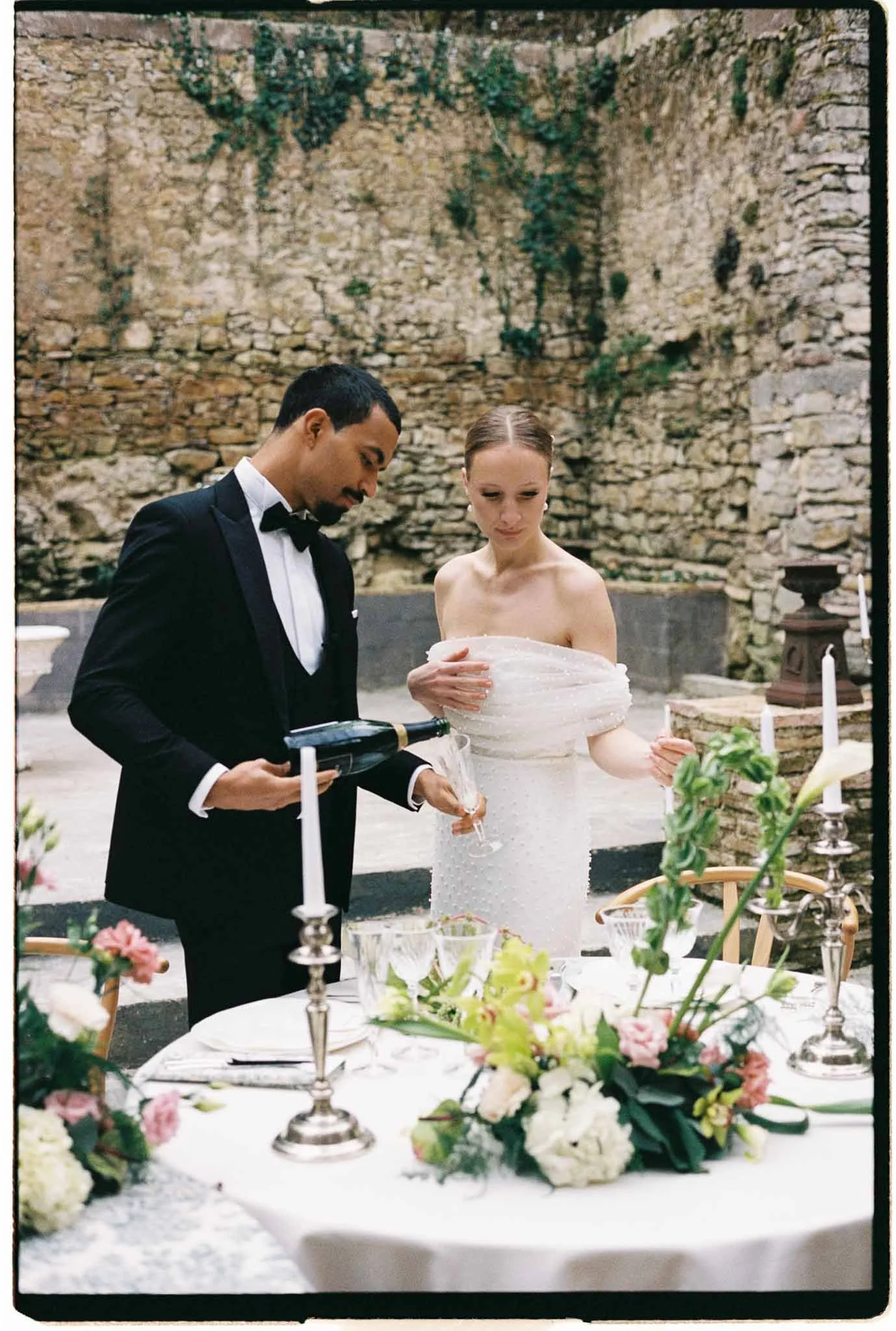 Chateau-du-Pont-Bourget-Lina-Bernard-bride-groom-reception-table-champagne-bottle-glass.jpg