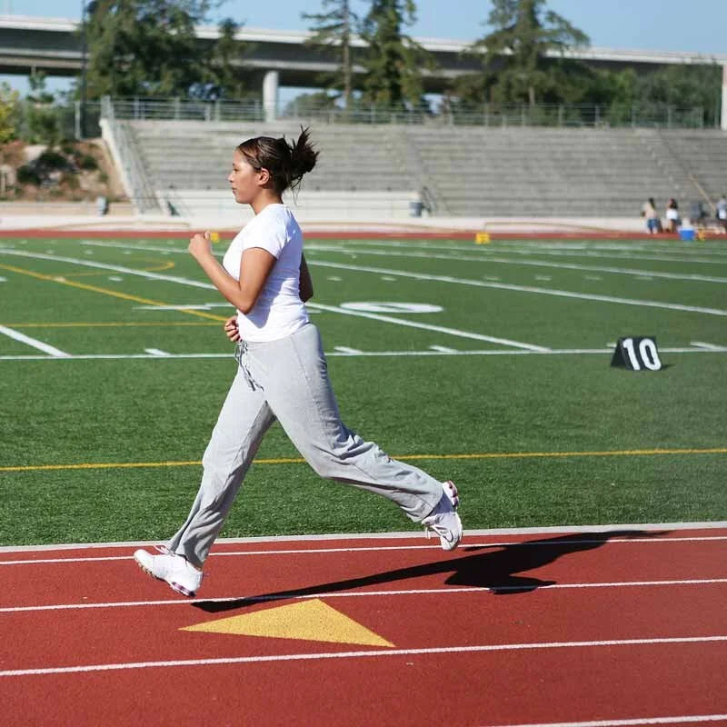 Woman jogging on a school track