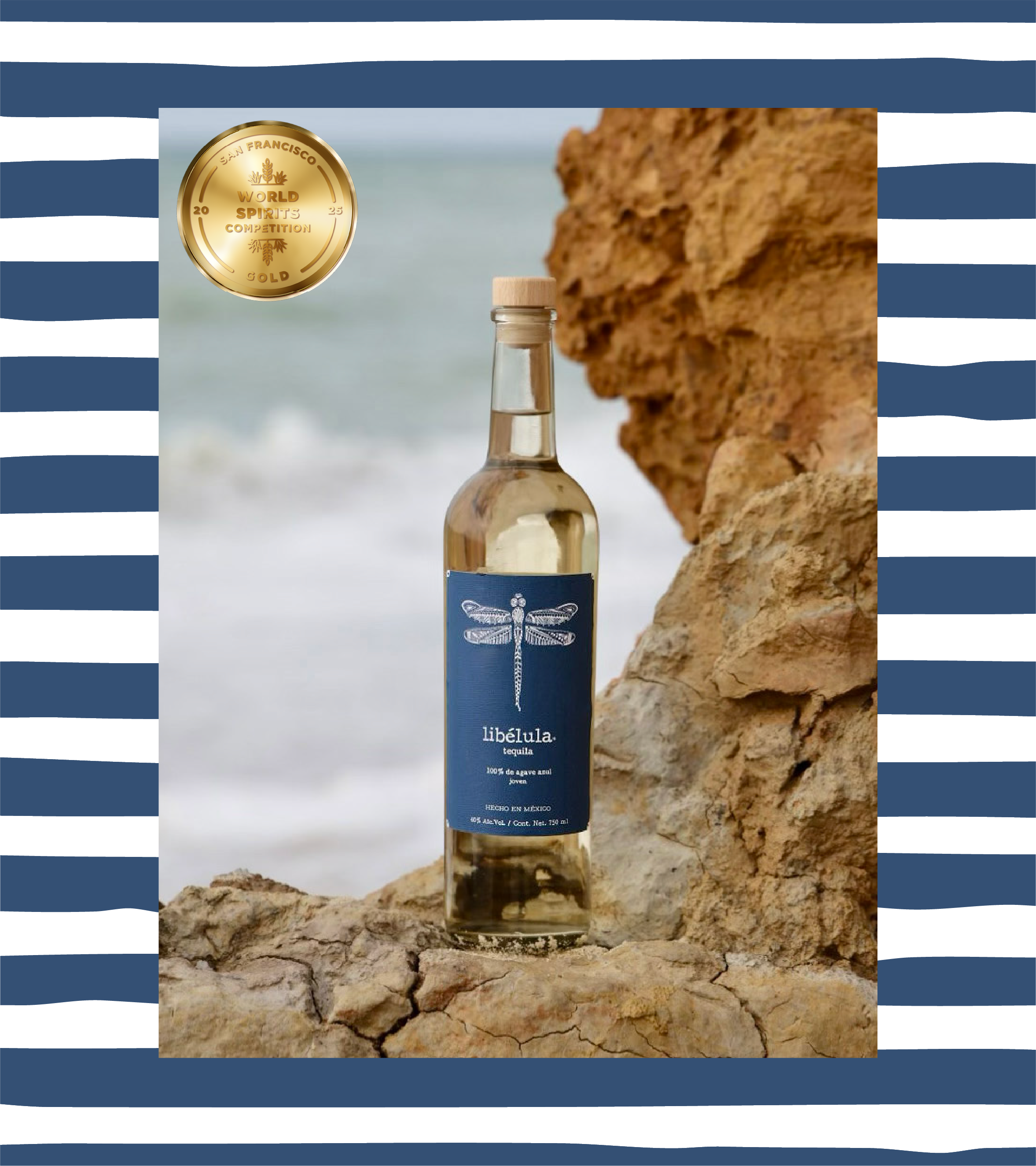 bottle of libélula joven tequila on a rocky ocean cliff.