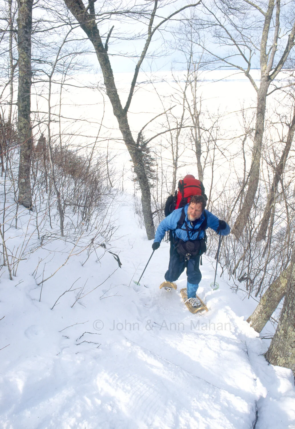 ID_37-6771B Pictured Rocks -- Winter Camper Snowshoeing up a steep hill