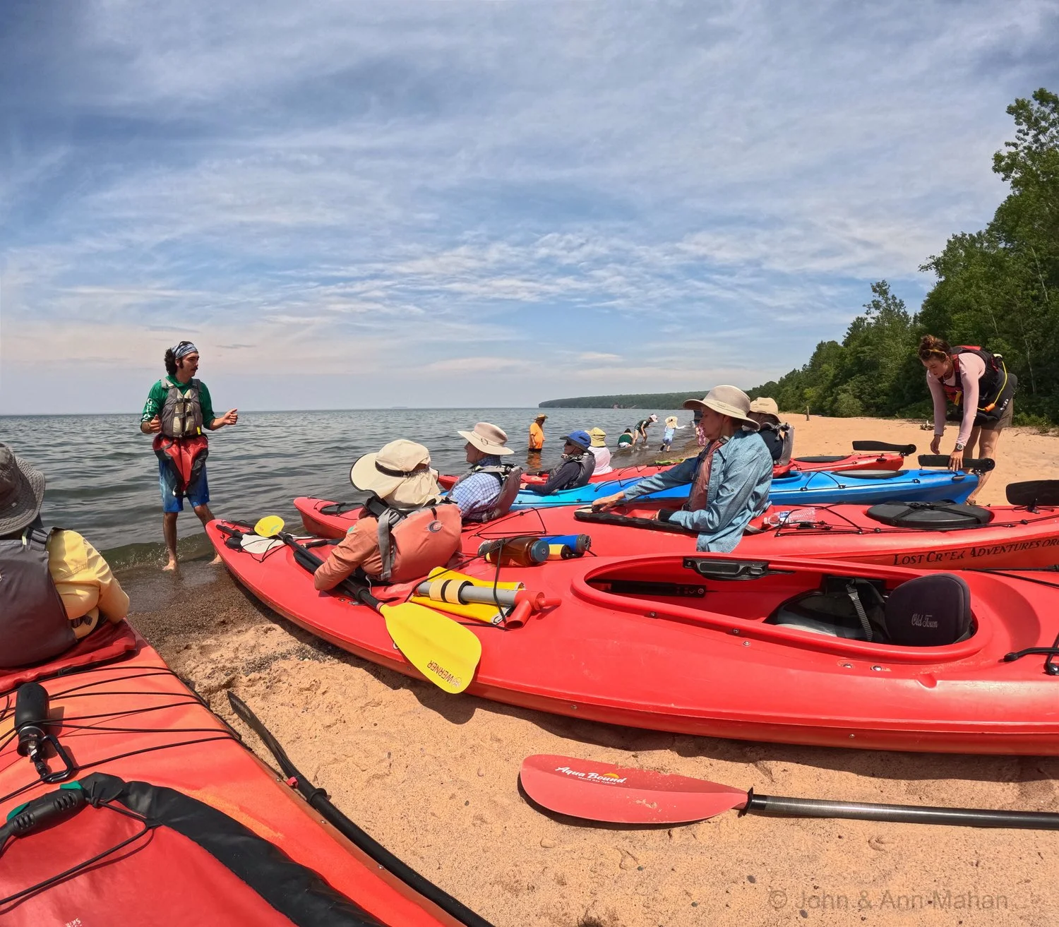 Kayakers preparing to depart, with instructions from Lost Creek Adventures Guides