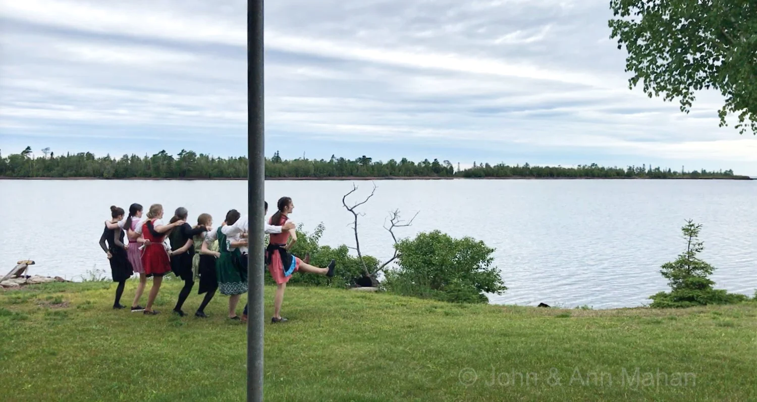 Keweenaw Peninsula Coach Tour -- Wait staff at Harbor Haus Restaurant in Copper Harbor dancing for Isle Royale Queen ferry as it returns from Isle Royale