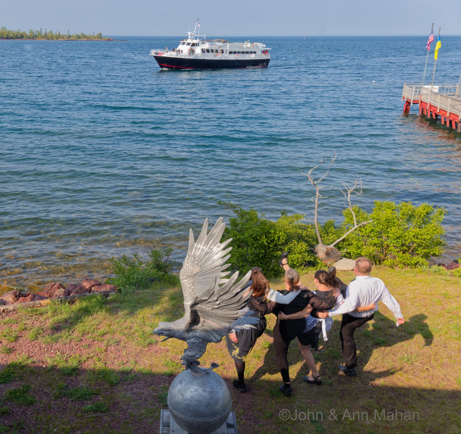 Keweenaw Peninsula Coach Tour -- Wait staff at Harbor Haus Restaurant in Copper Harbor dancing for Isle Royale Queen ferry as it returns from Isle Royale