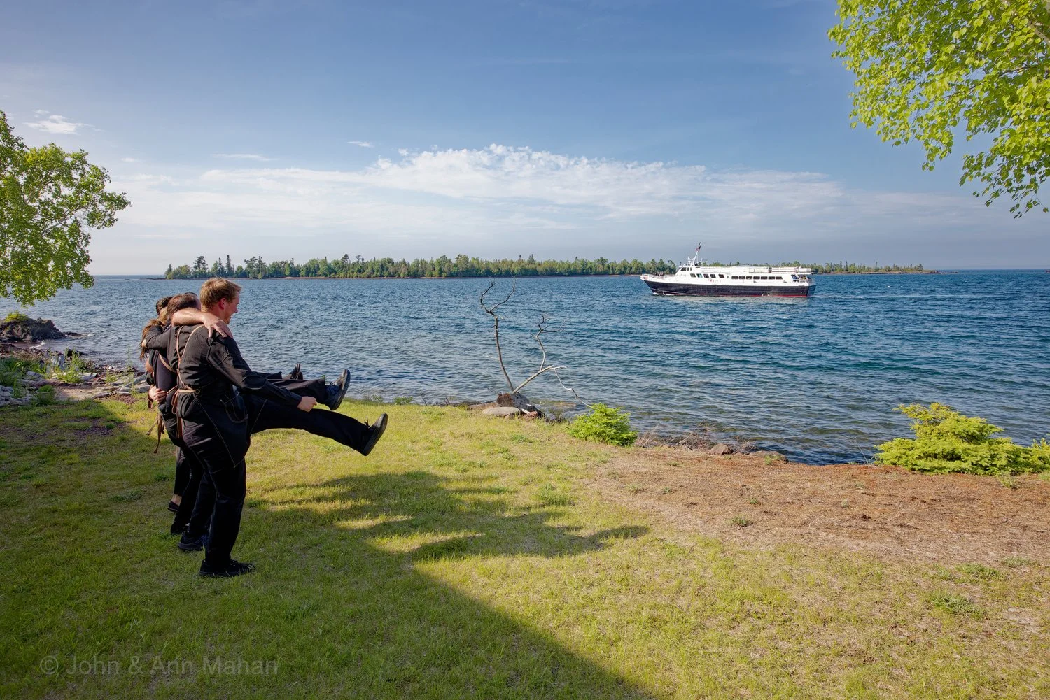 Keweenaw Peninsula Coach Tour -- Wait Staff at Harbor Haus Restaurant in Copper Harbor dancing for Isle Royale Queen ferry as it returns from Isle Royale