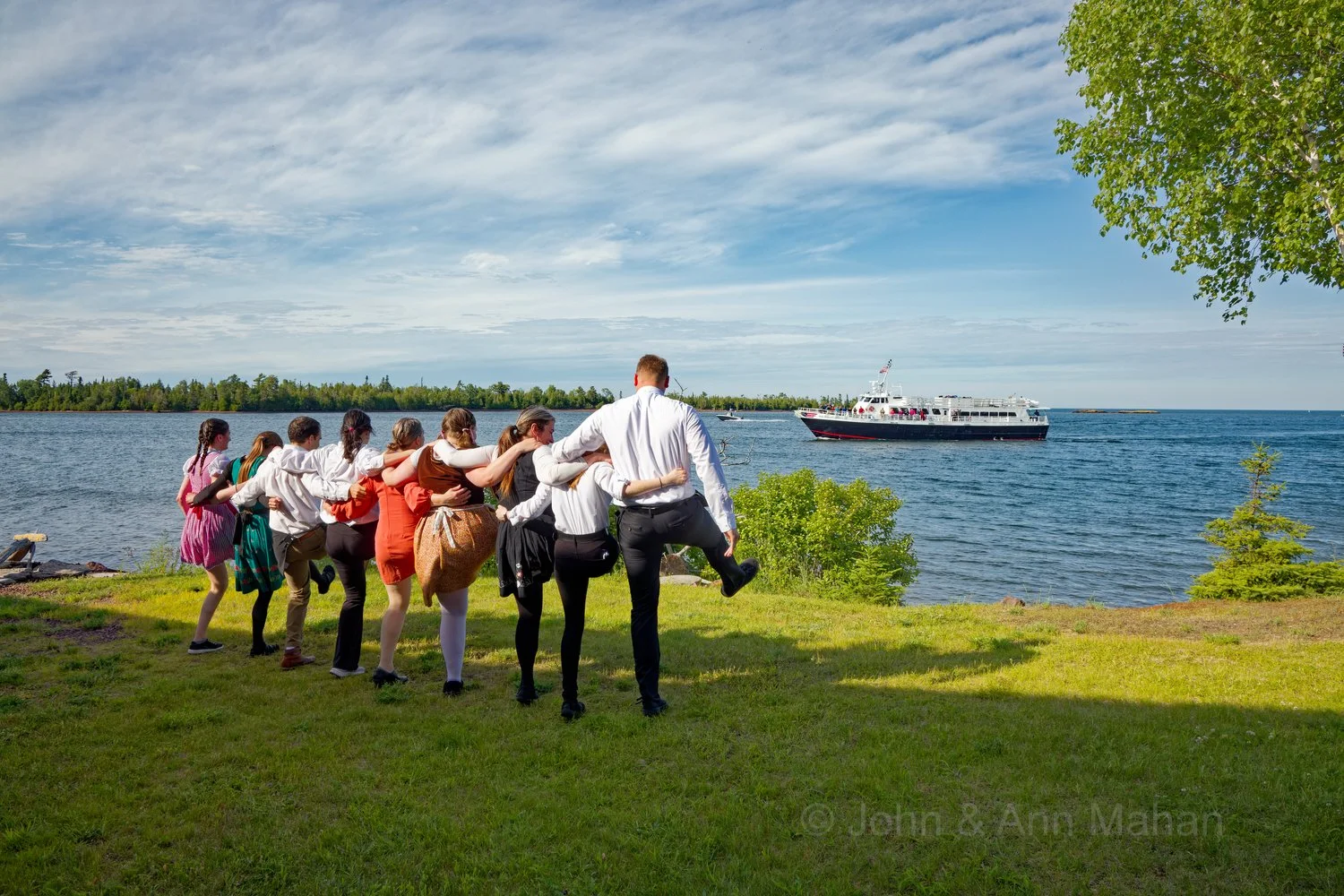 Keweenaw Peninsula Coach Tour -- Wait Staff at Harbor Haus Restaurant in Copper Harbor dancing for Isle Royale Queen ferry as it returns from Isle Royale