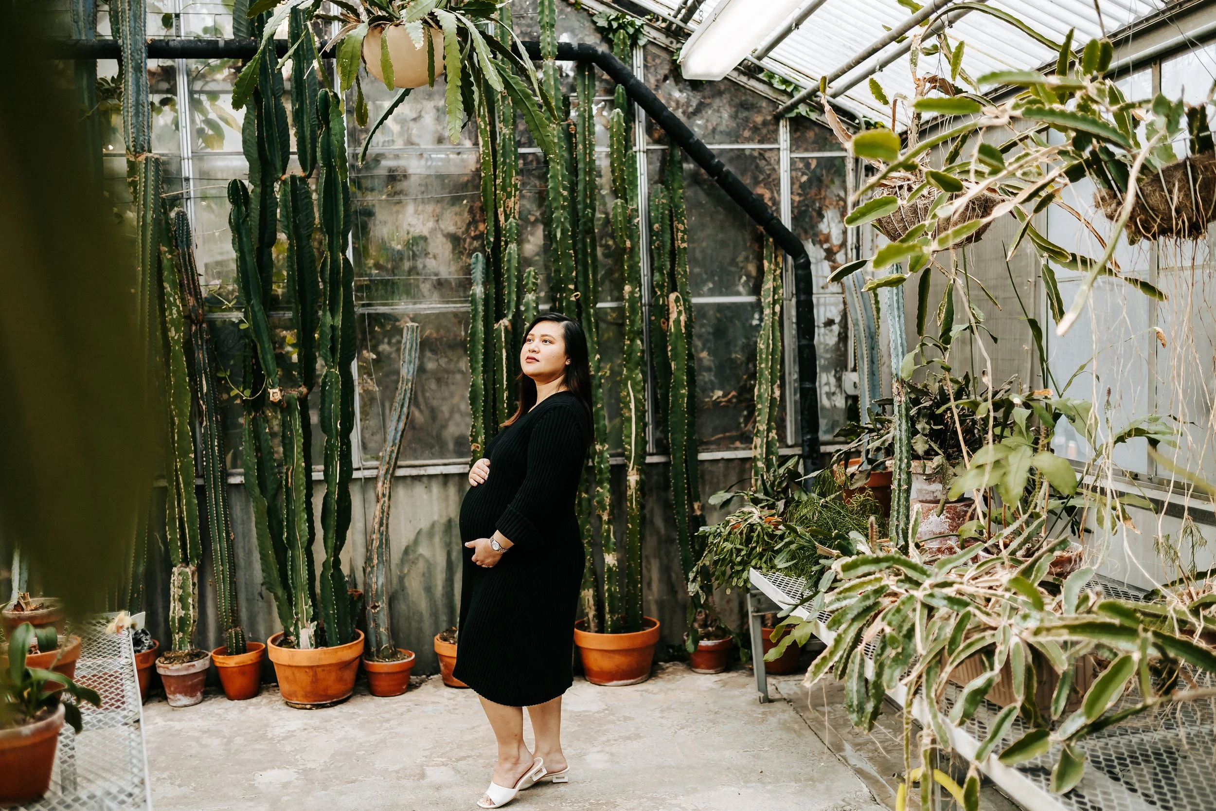 Soft, light-filled maternity and family session at the Greenhouse at Mann Leiser in Alaska surrounded by lush greenery, natural textures, and gentle light. A beautiful space for capturing connection, love, and growing families.