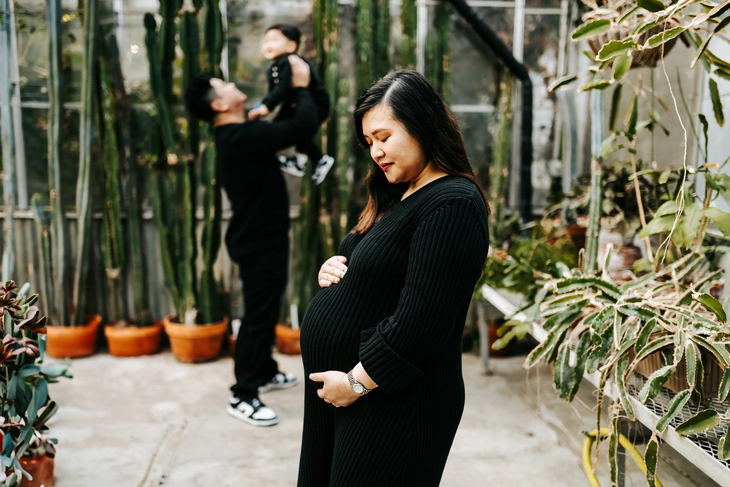 Soft, light-filled maternity and family session at the Greenhouse at Mann Leiser in Alaska surrounded by lush greenery, natural textures, and gentle light. A beautiful space for capturing connection, love, and growing families.