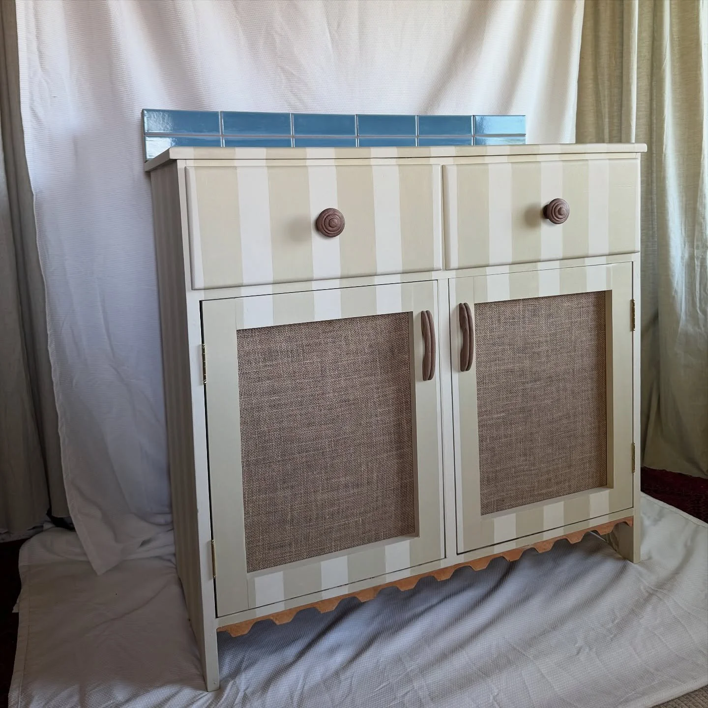 Selling this cutie! It would make an adorable changing table for a nursery, a funky bar cart in a studio, a colorful buffet cabinet for your dining room. We rehabbed the base furniture, added a tiled backsplash, remade new doors out of the old door l