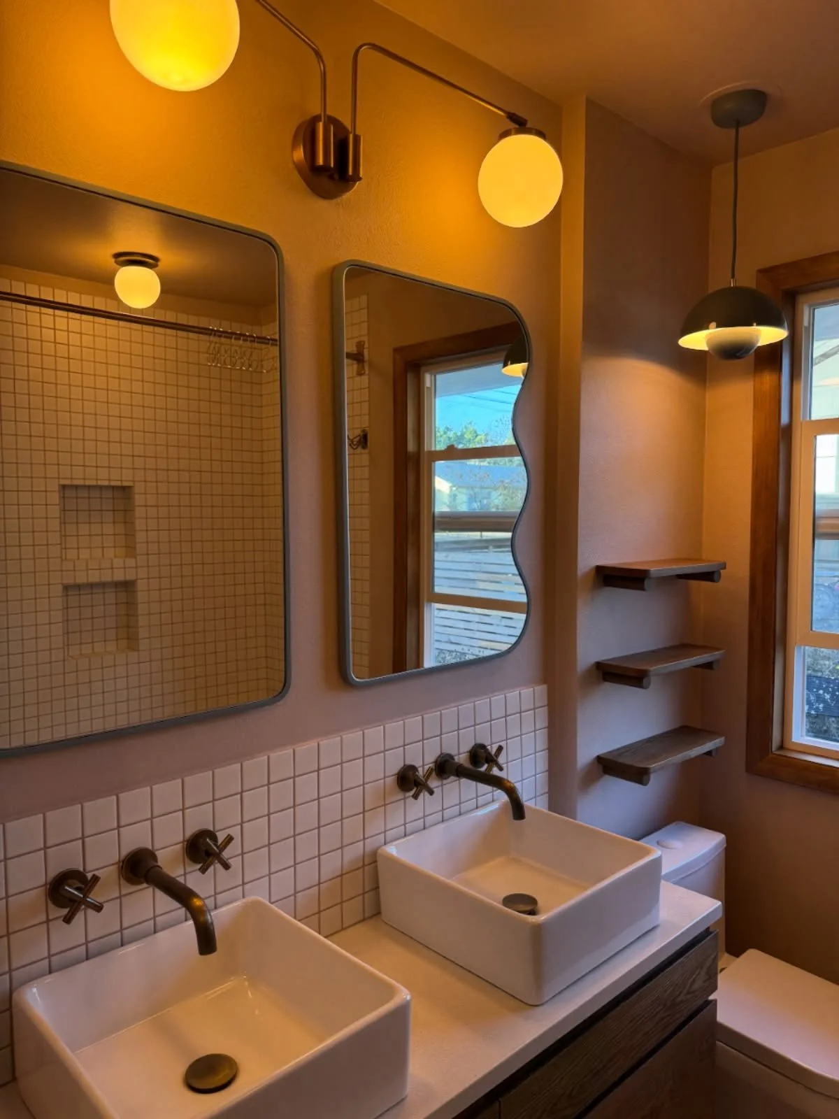 Night mode in the 1956 ranch MCM bathroom remodel. Highly functional spaces are both useful and emotive, making you feel good when you use them. We made so many changes to this space to achieve this from the new pocket door, new custom closet, double