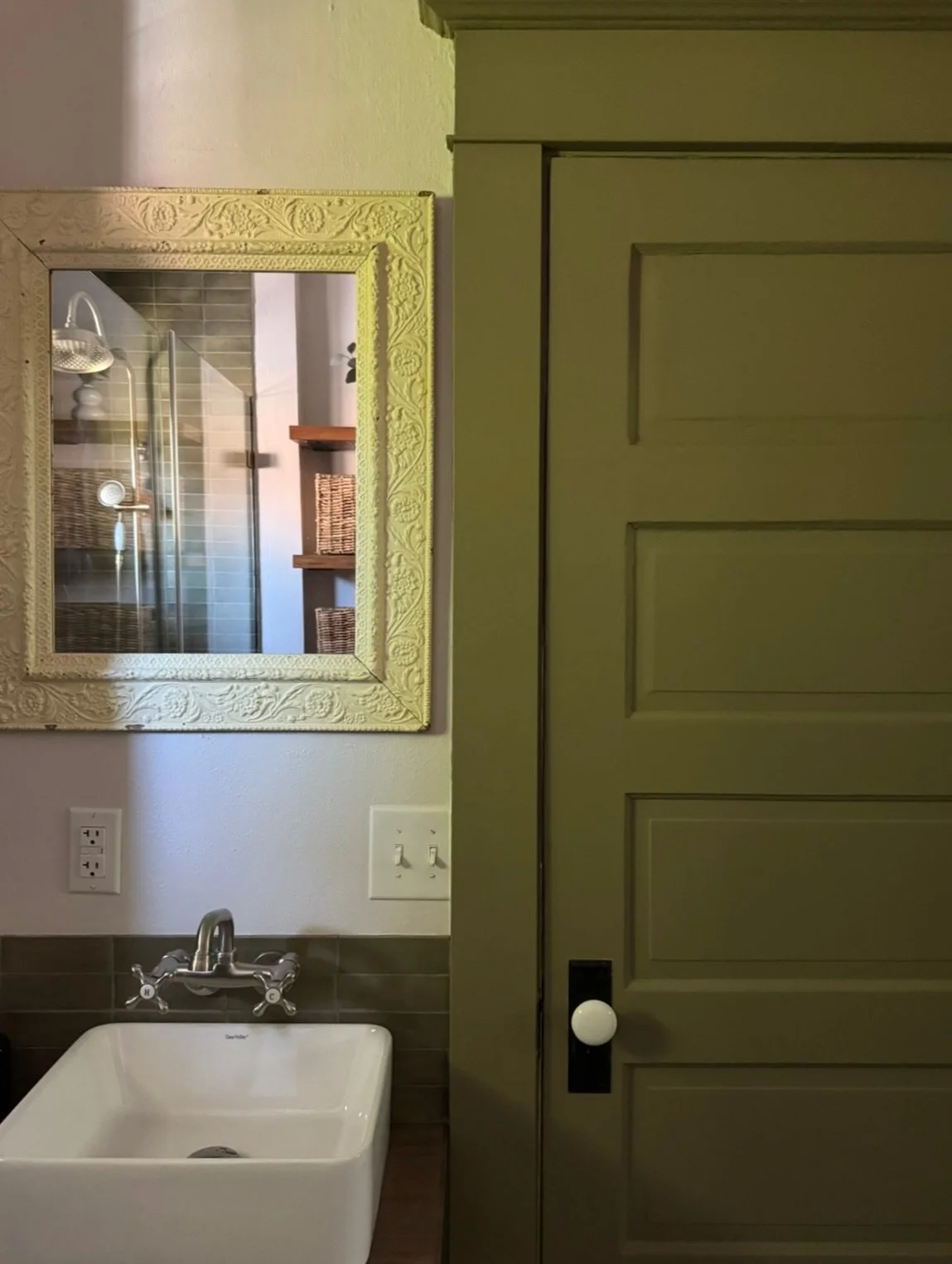 One of my favorite details in this bathroom is the vanity mirror sourced at a Sellwood antique mall. Most likely a 1910s&ndash;1930s American picture frame that was later transformed into a garden mirror. Its size, color, and patina felt perfectly ma