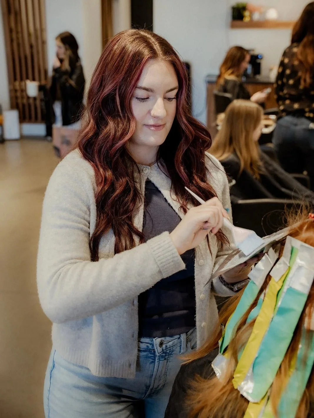 Stylist foiling custom color on a client.