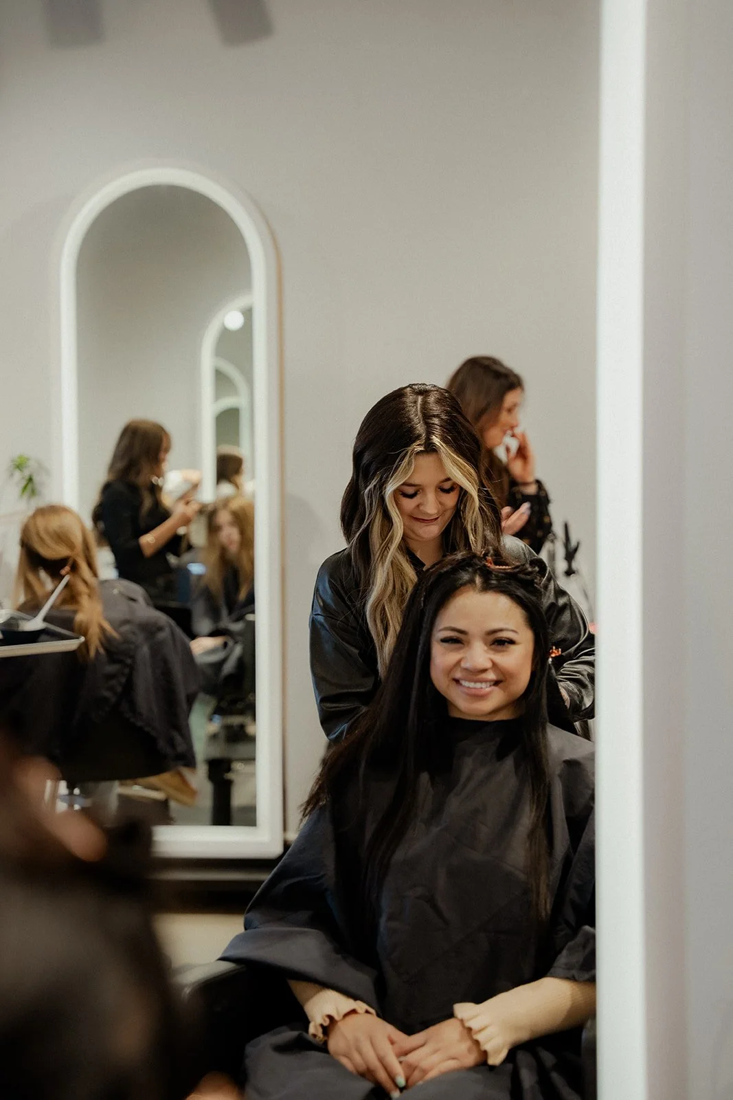 A mix of clients and hair stylists at LB Extensions salon during service hours.