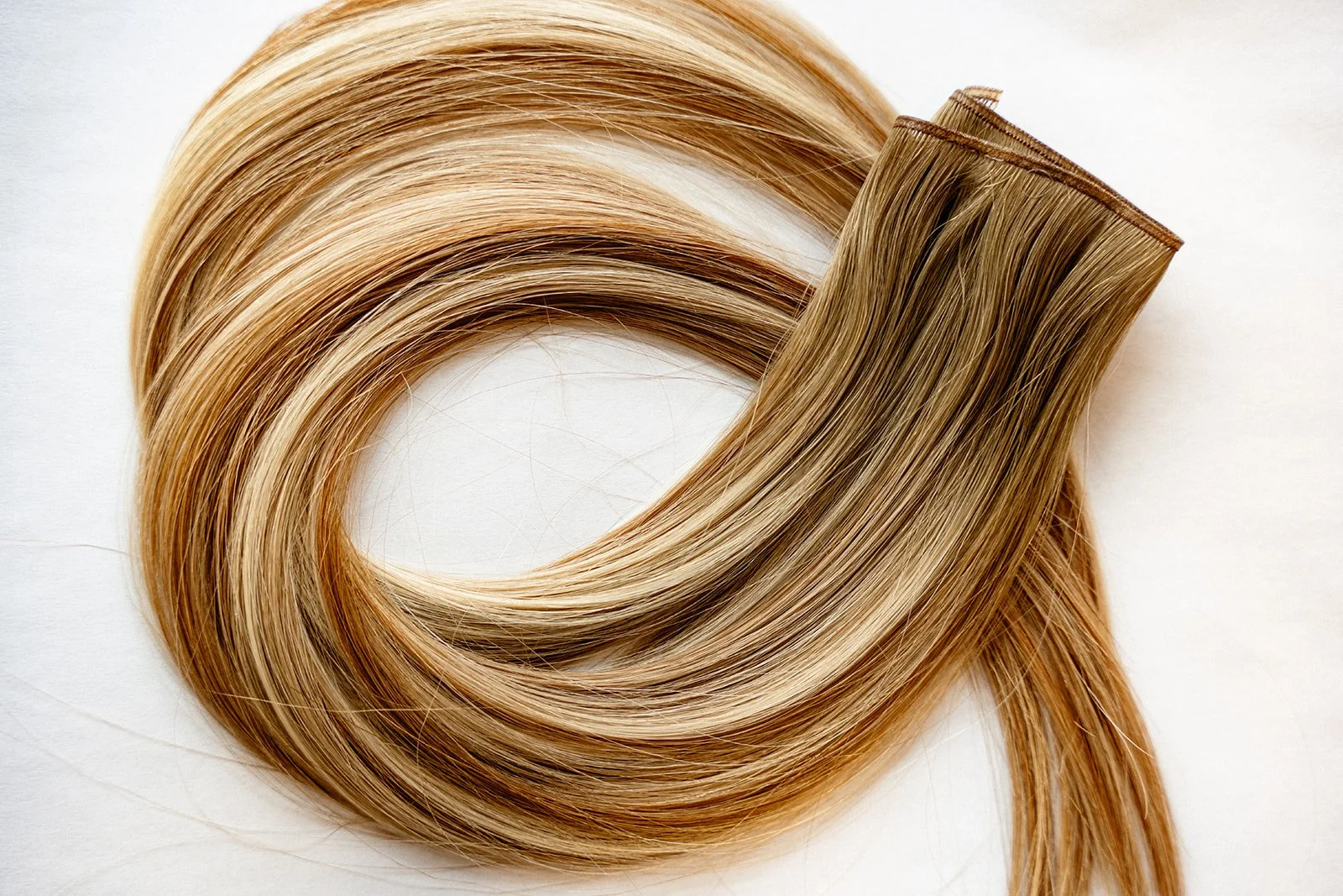 Close up of blonde hair extensions.
