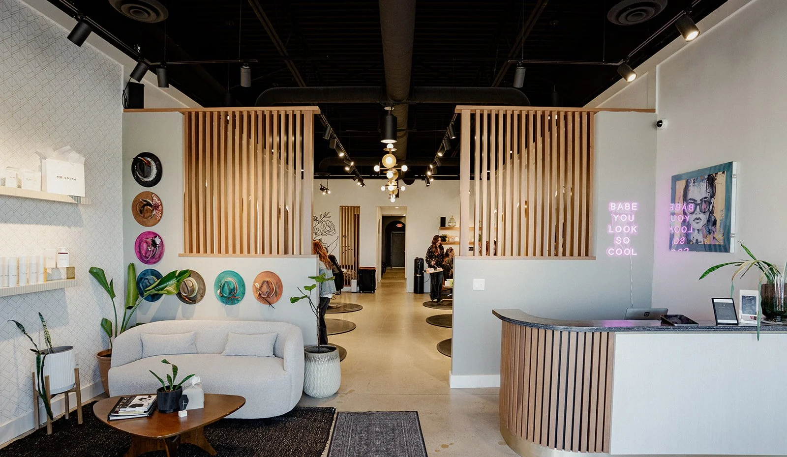 Front entrance of LB Extensions Salon with stylists working in the background.