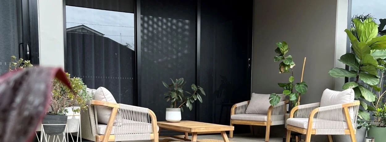 Outdoor patio area with aluminum security screens installed to a set of sliding stacker doors