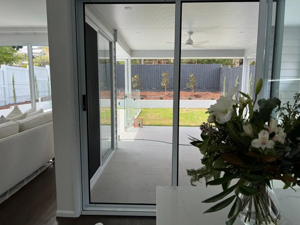 View of a backyard through stainless steel mesh security screen in brisbane