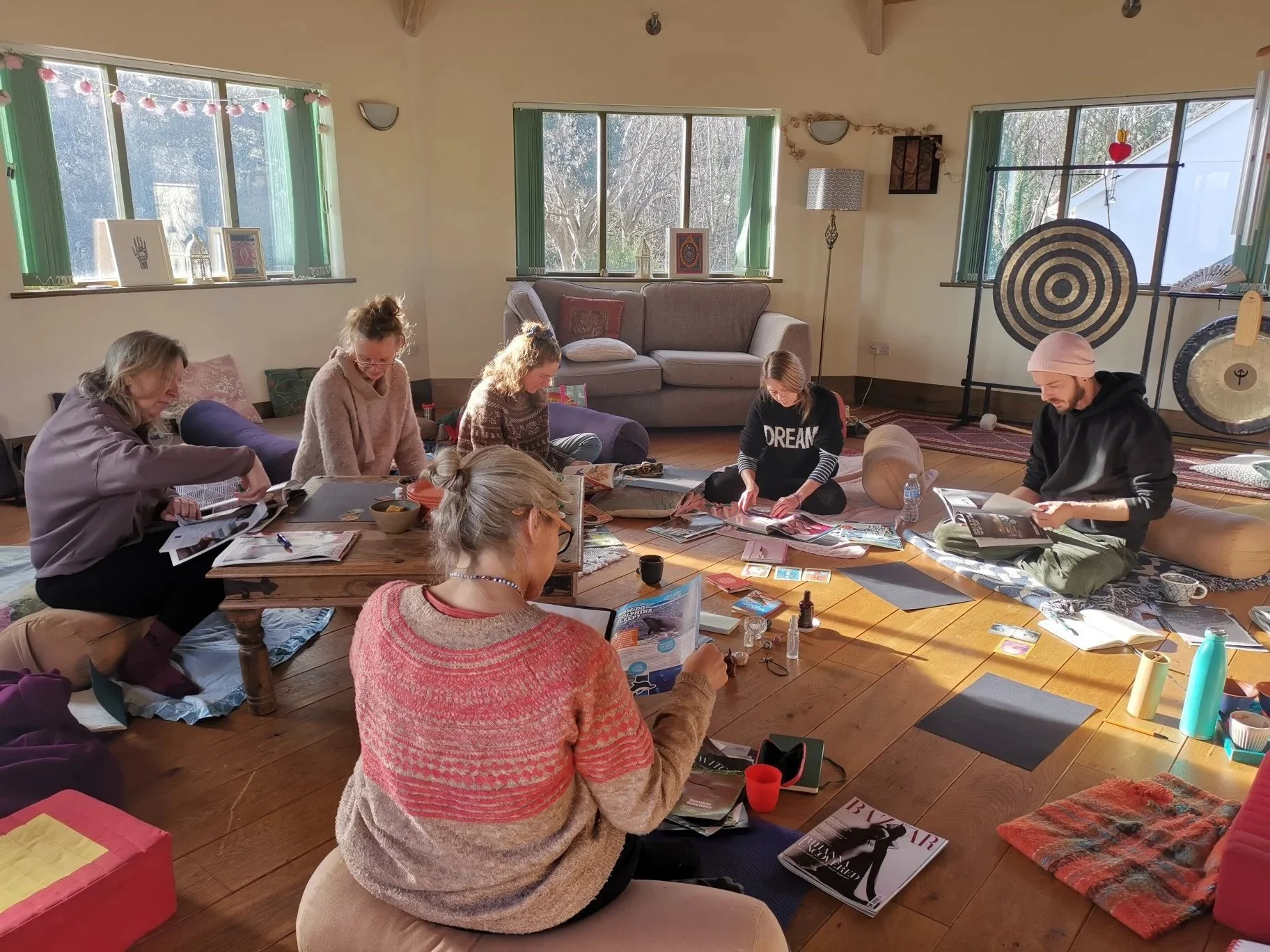 Participants calmly creating vision boards at Kari Herbert's workshop