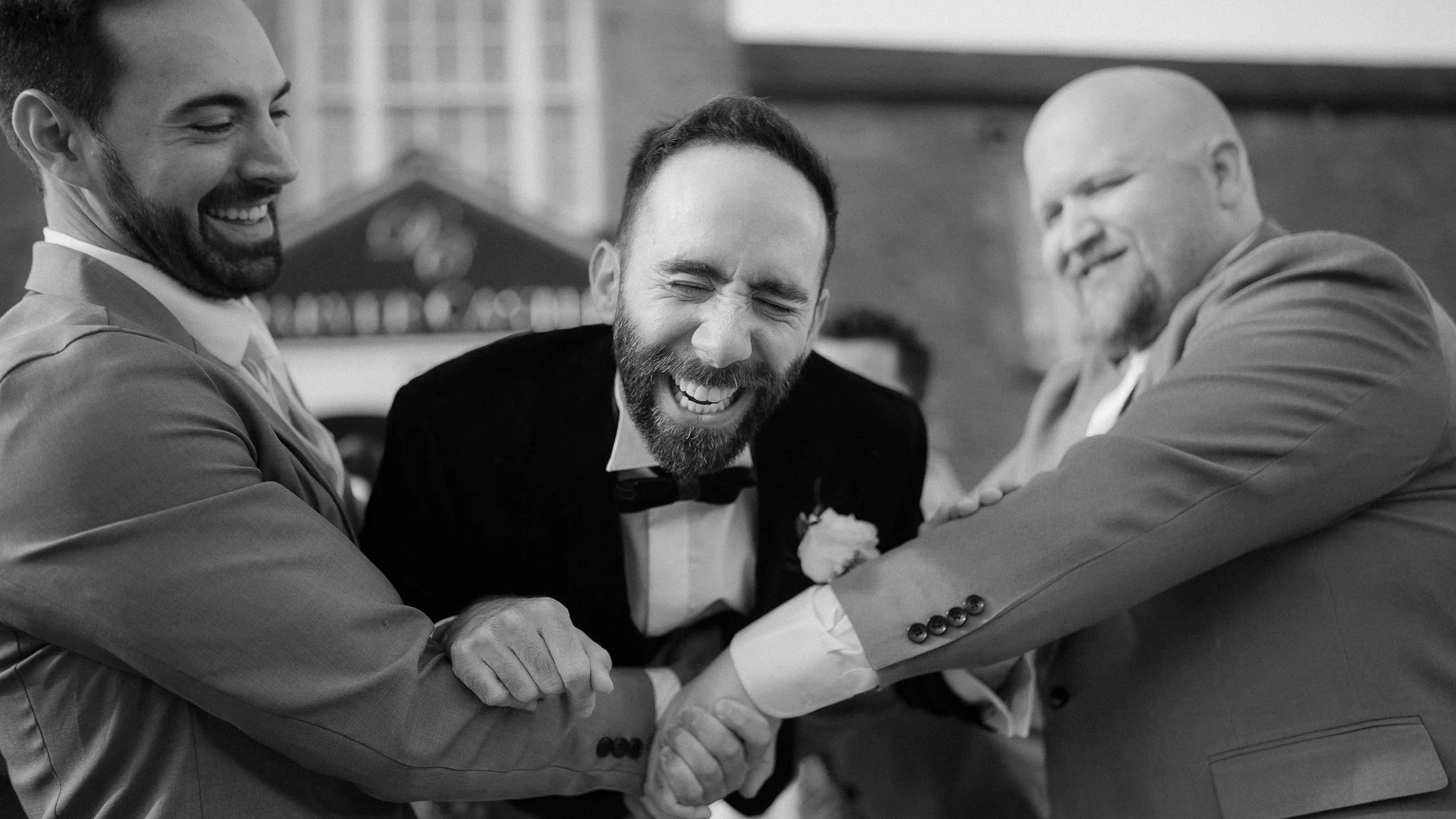 Groomsmen laughing with the groom outside Darver Castle on the wedding day