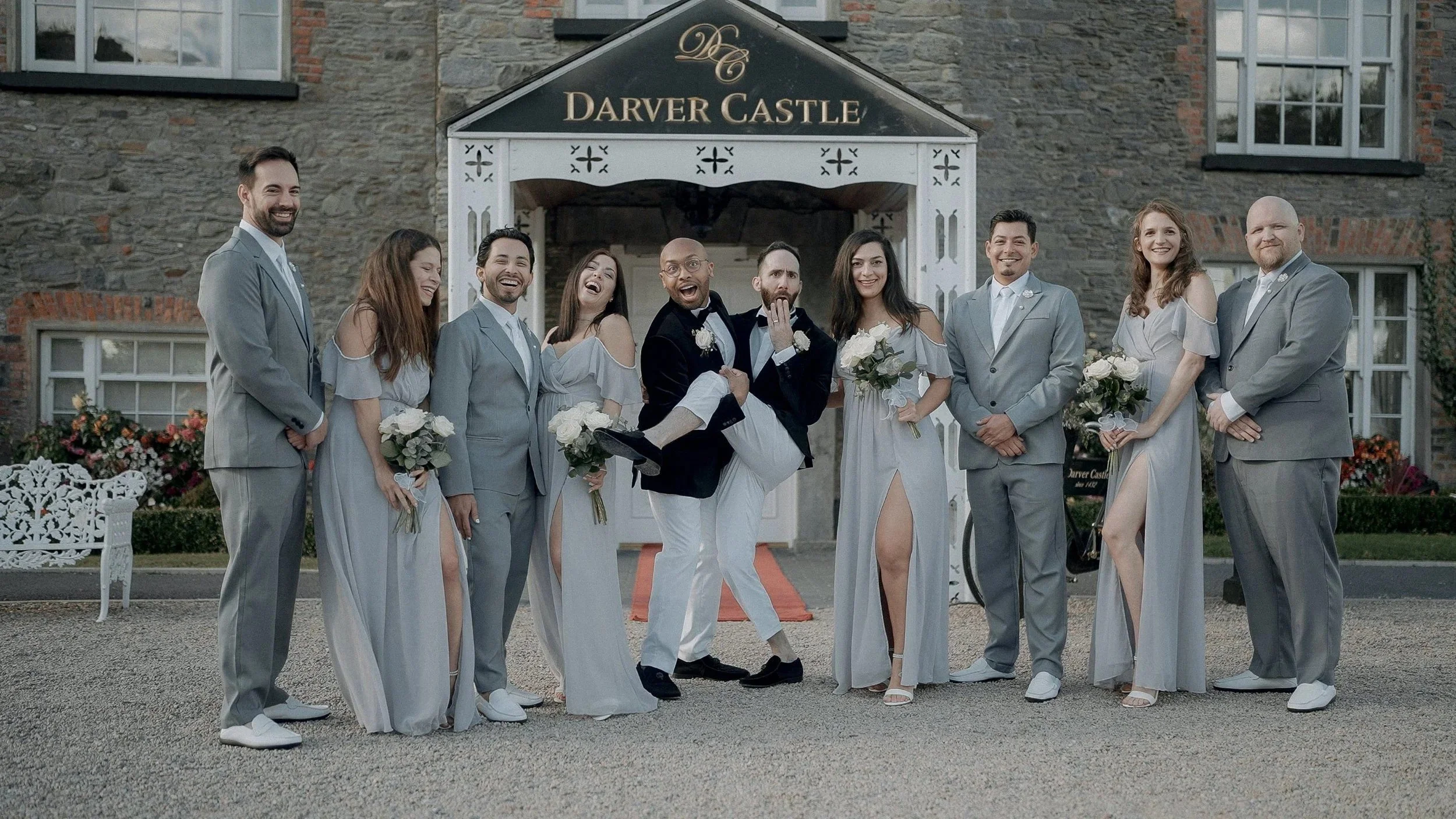 Wedding party in grey under the white porch of Darver Castle, Co. Louth