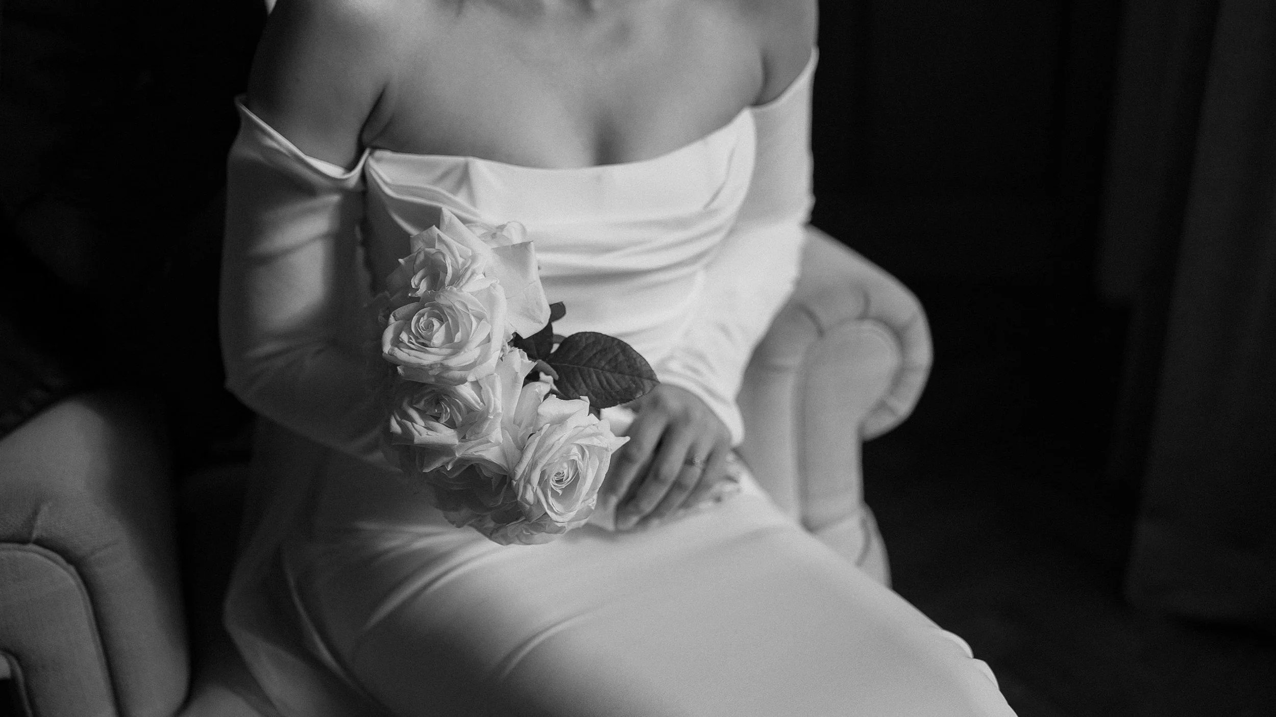 Black and white detail of the bridal bouquet of white roses at a Farnham Estate wedding
