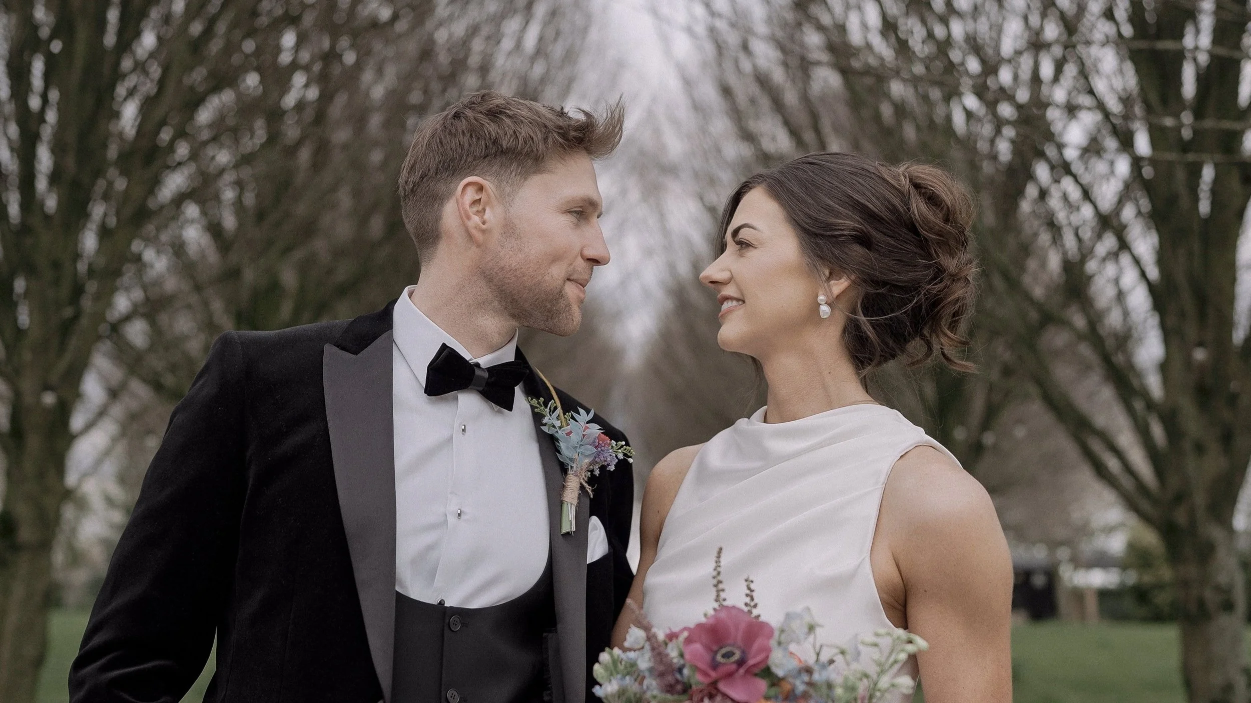 Close-up portrait of the bride and groom on the tree-lined avenue at Barberstown Castle