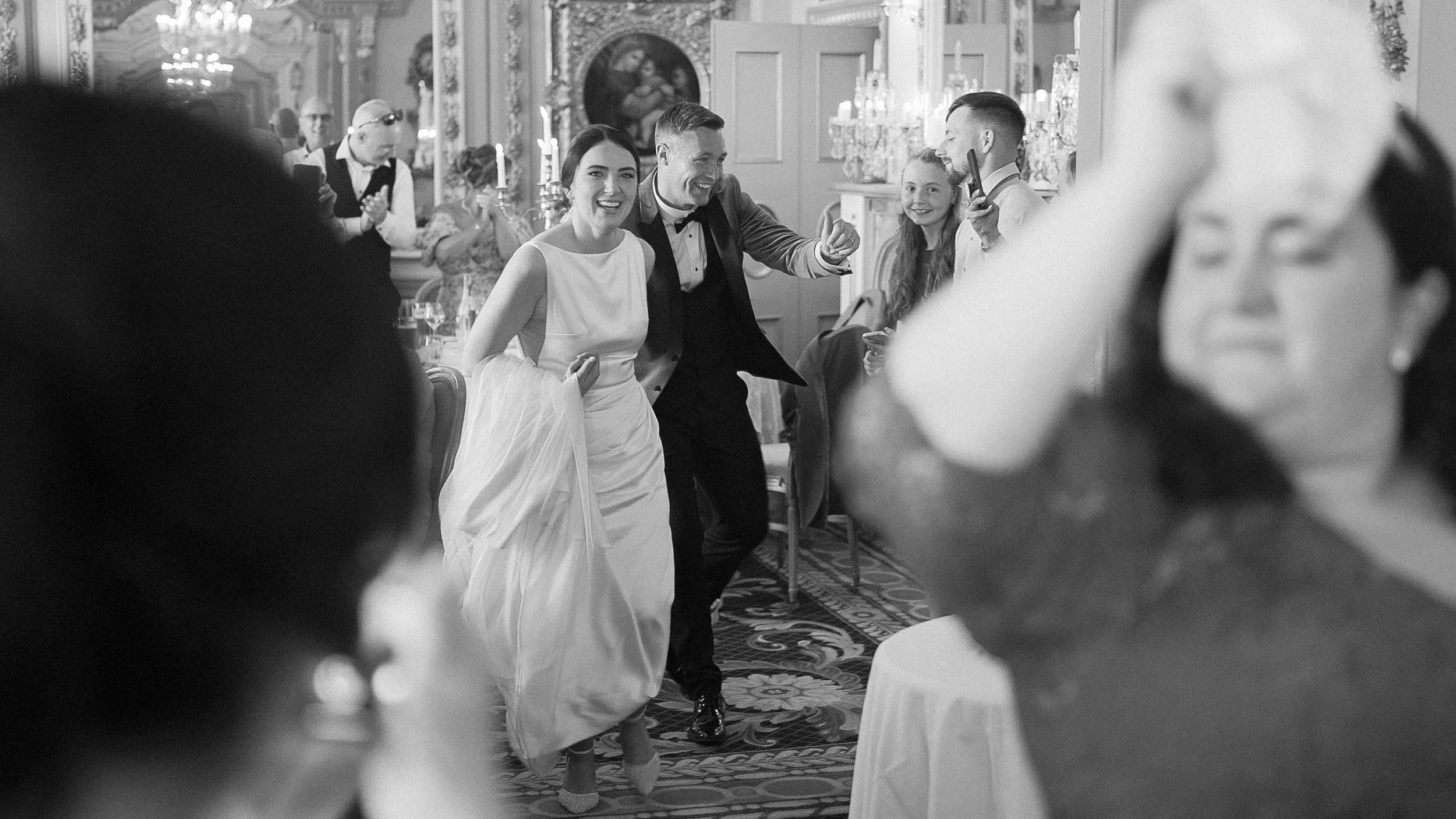 Bride and groom making their entrance into the gilded dining room at Markree Castle, black and white