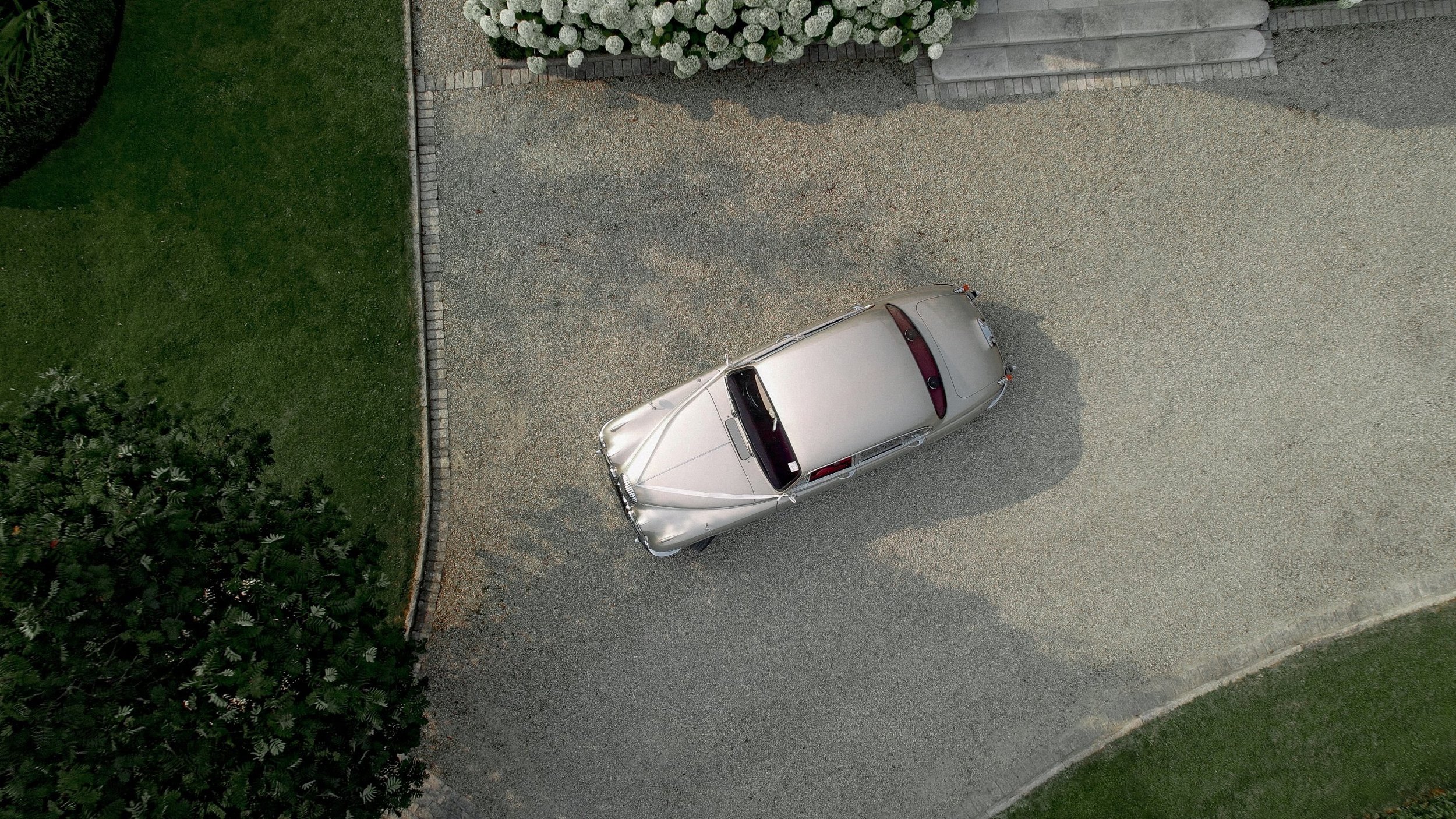 Aerial view of a vintage wedding car on the driveway of a family home on The Curragh