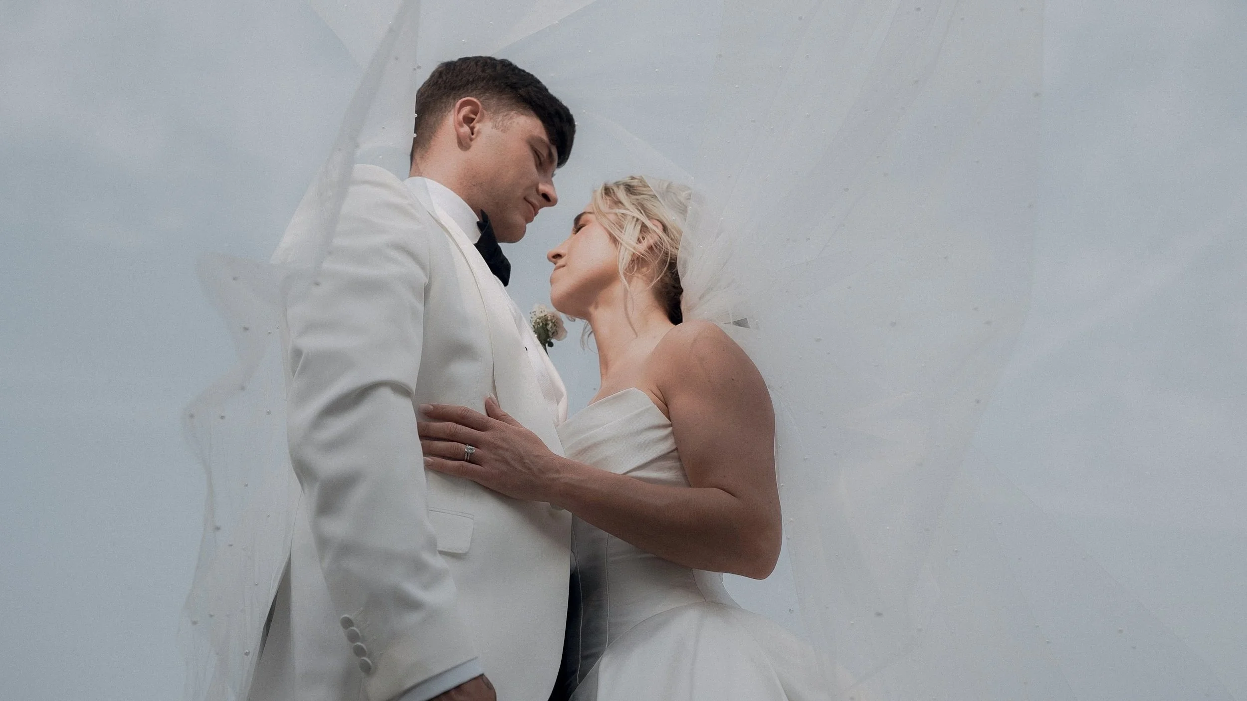 Bride and groom under a pearl-scattered veil, Curragh wedding in Co. Kildare