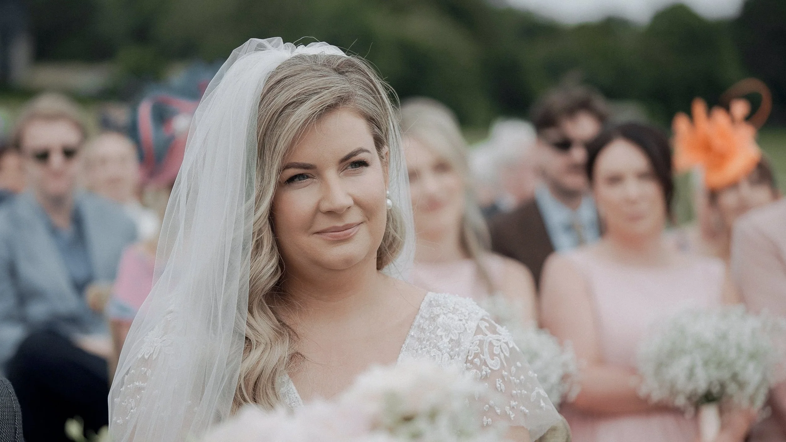 Bride smiling during her outdoor wedding ceremony at Glasson Lakehouse, Athlone