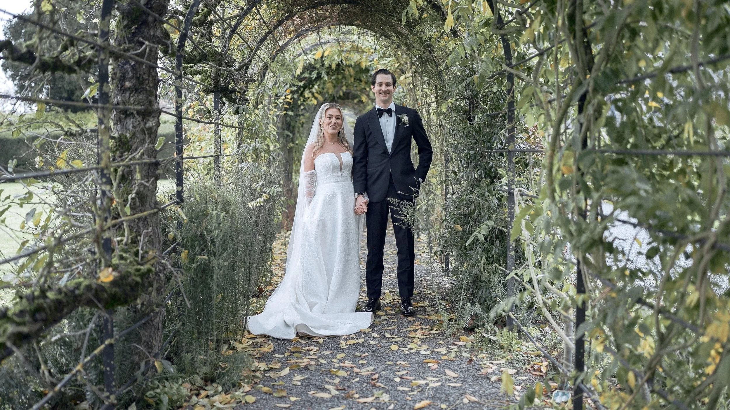 Bride and groom in the covered garden walk at Kilkea Castle in autumn, Co. Kildare